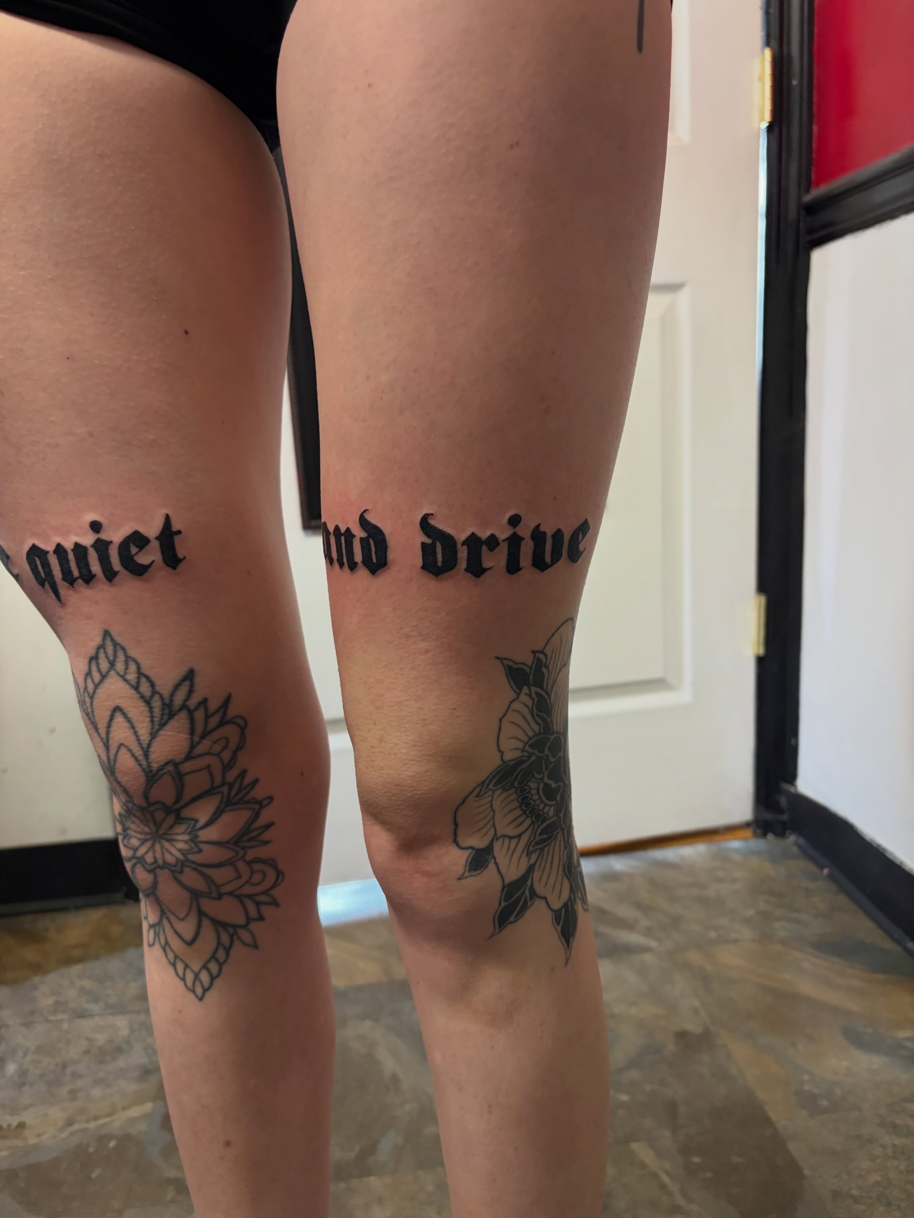 Lotus flower black and grey tattoo on the leg by Vudu Tattooer