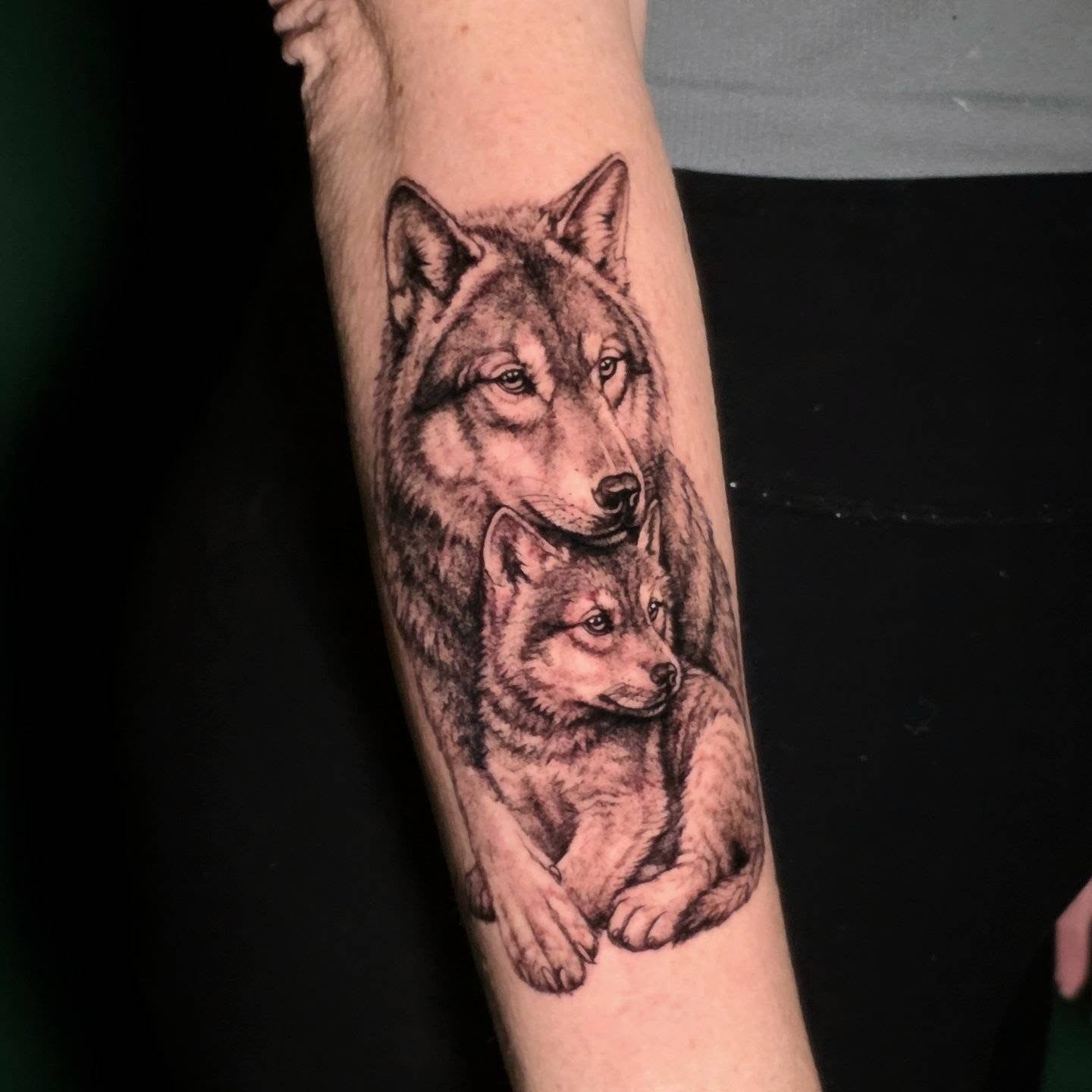 Wolves realism tattoo on the forearm by Nick de Hoyos