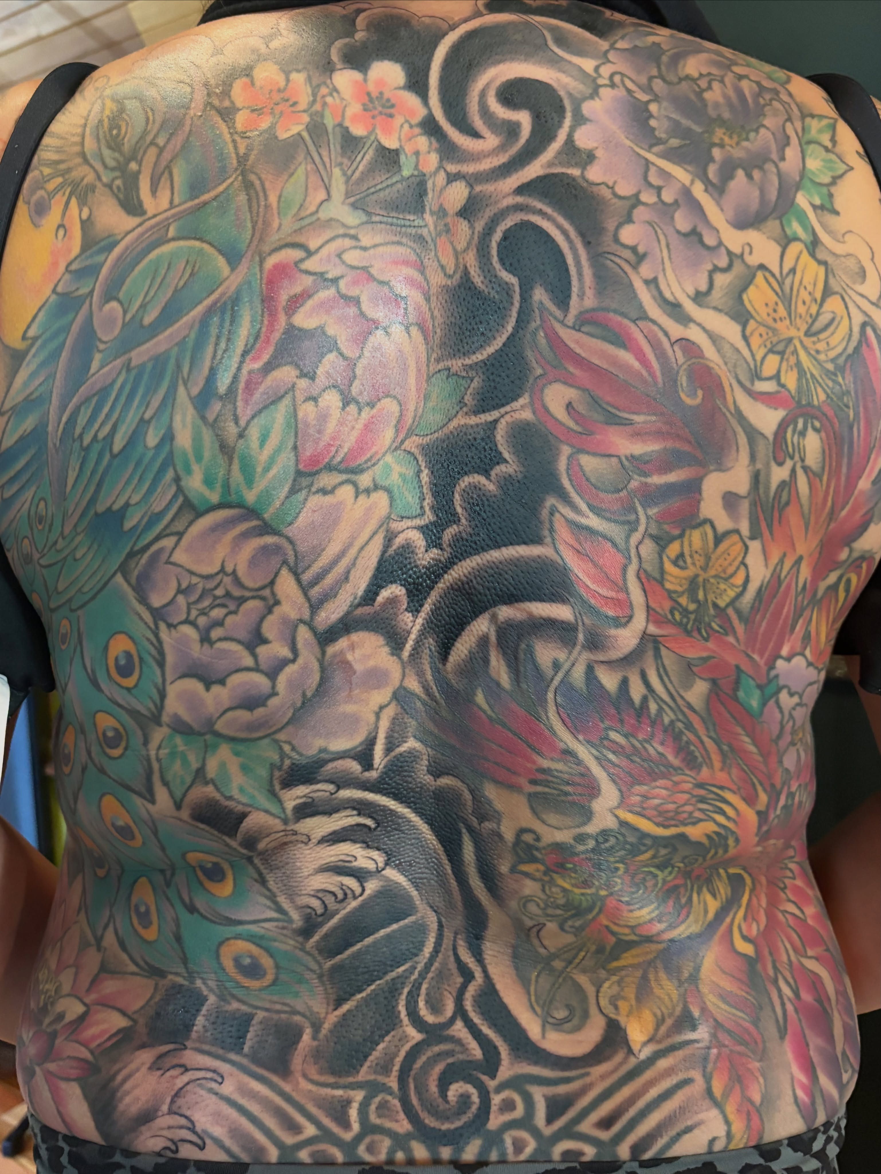 Peacock and floral japanese irezumi tattoo on the back by Komfort Kristy