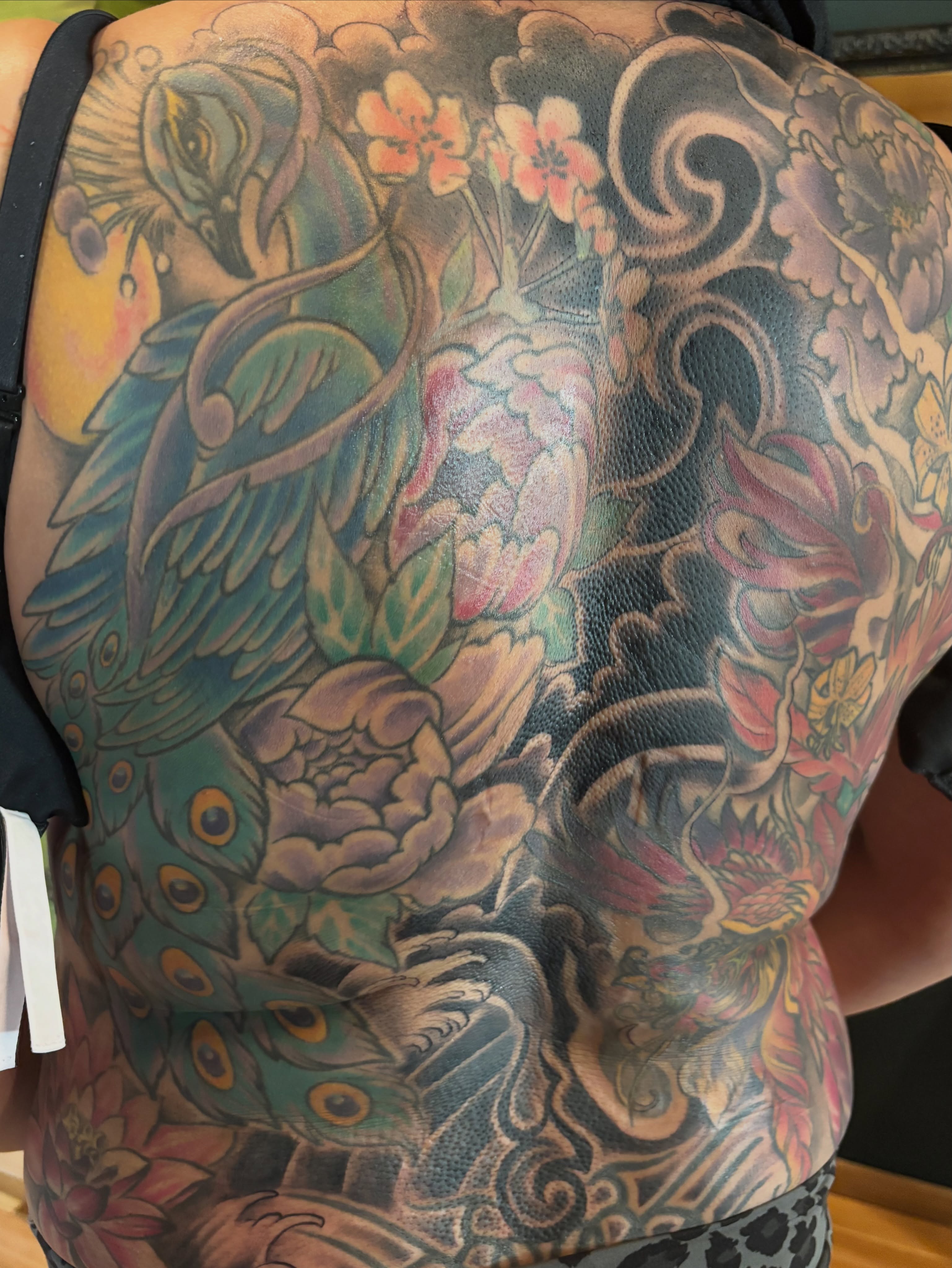Peacock and floral japanese irezumi tattoo on the back by Komfort Kristy