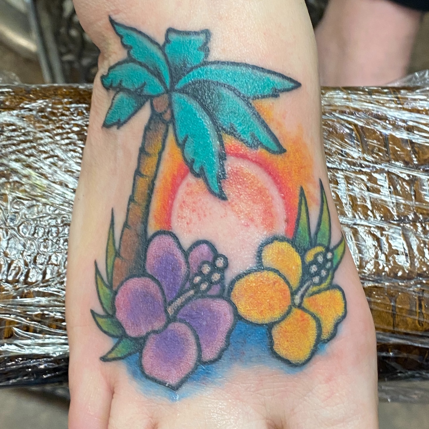 Palm tree and flowers American traditional tattoo on the hand by Rob White