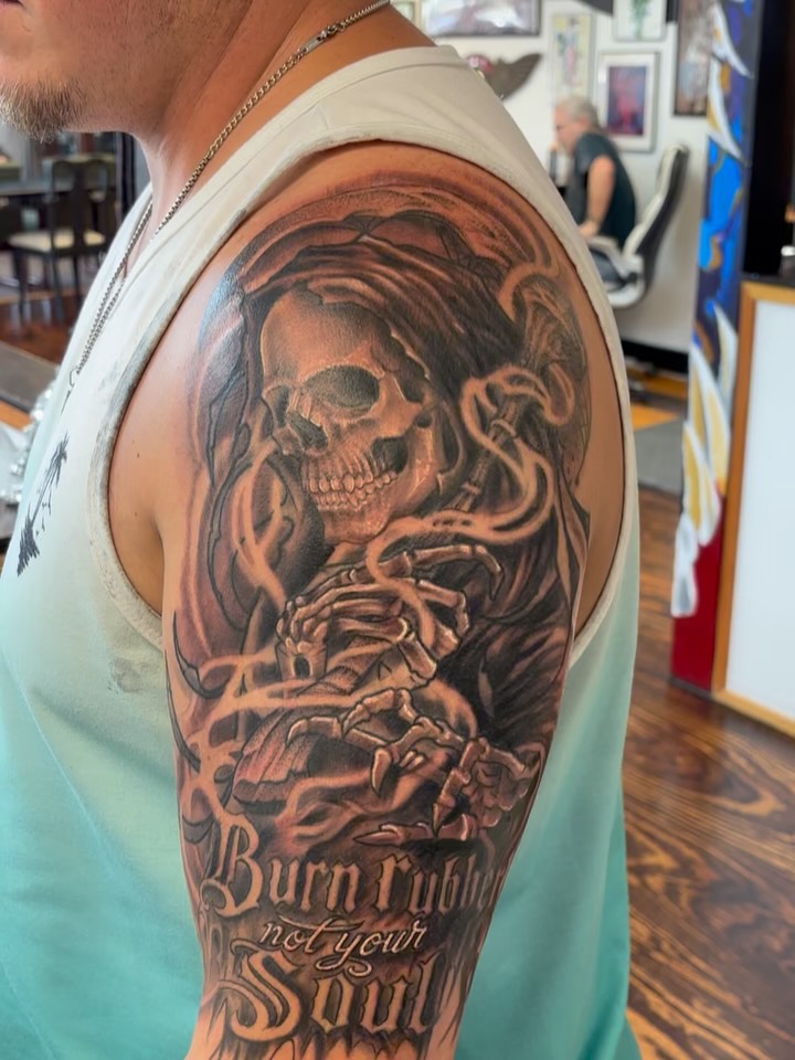 Burn rubber not your soul realism tattoo on the upper arm by Sam Hearnen, Lawrence, Kansas