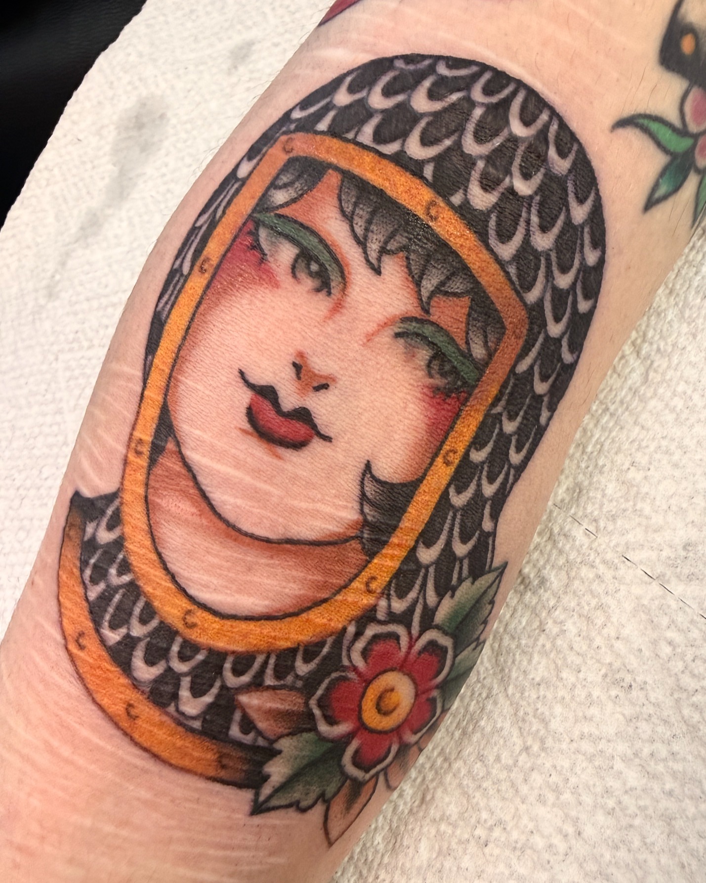 Woman's face American traditional tattoo on the forearm by Penny D Tattoos