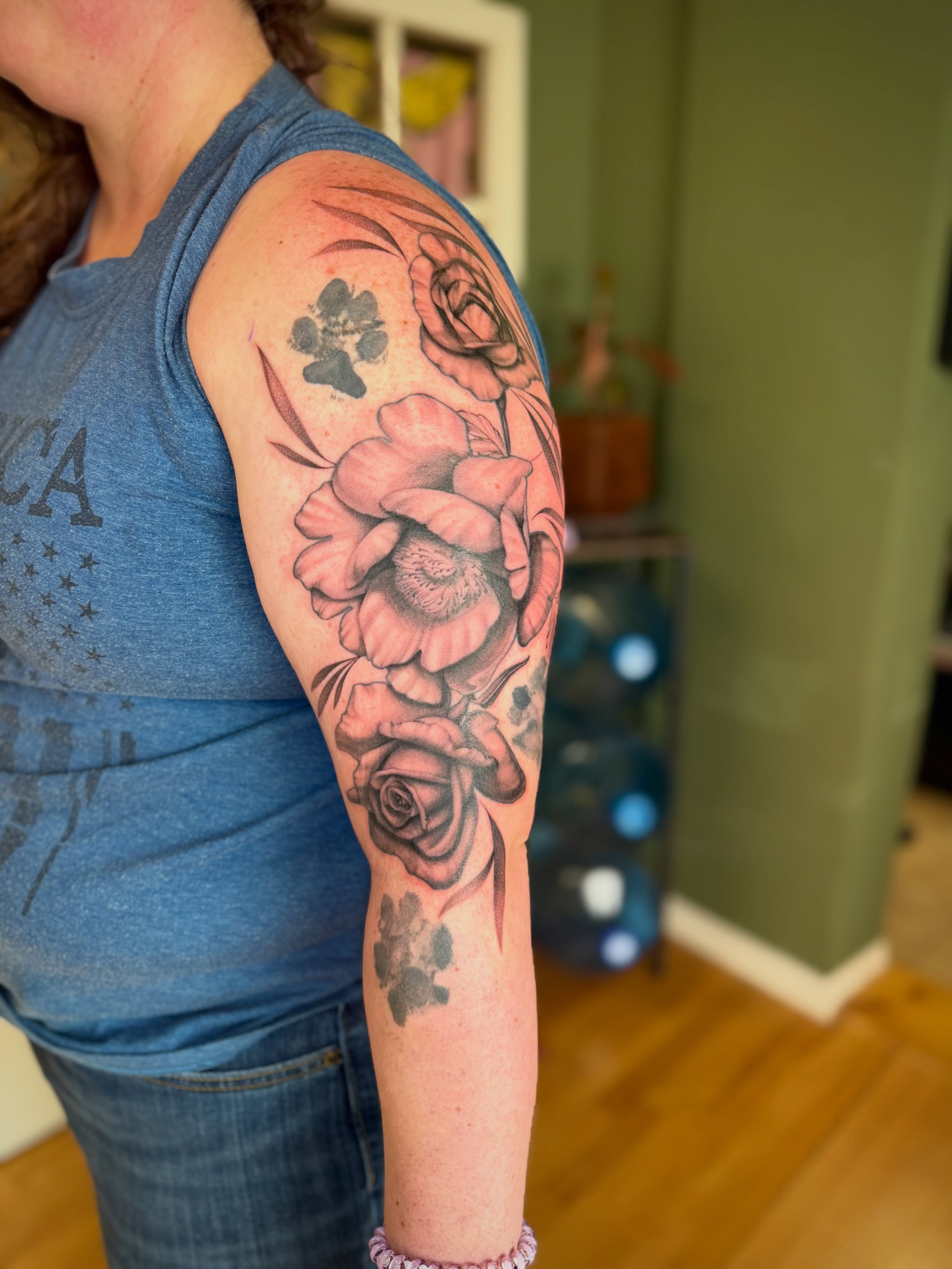 Roses and paw prints realism tattoo on the upper arm by ๐ฎ Kira Yamanashi