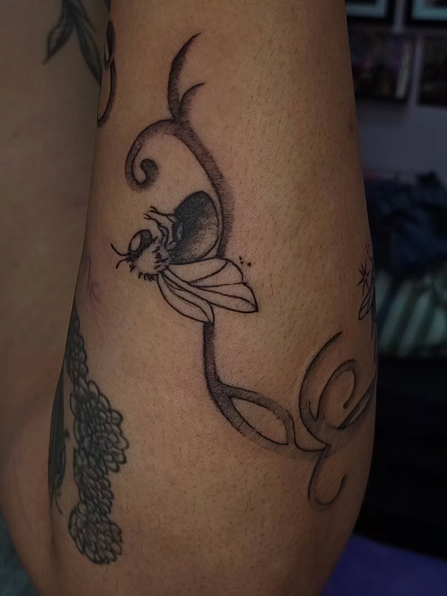 Bee and flower black and grey tattoo on the forearm by Luna 🌙