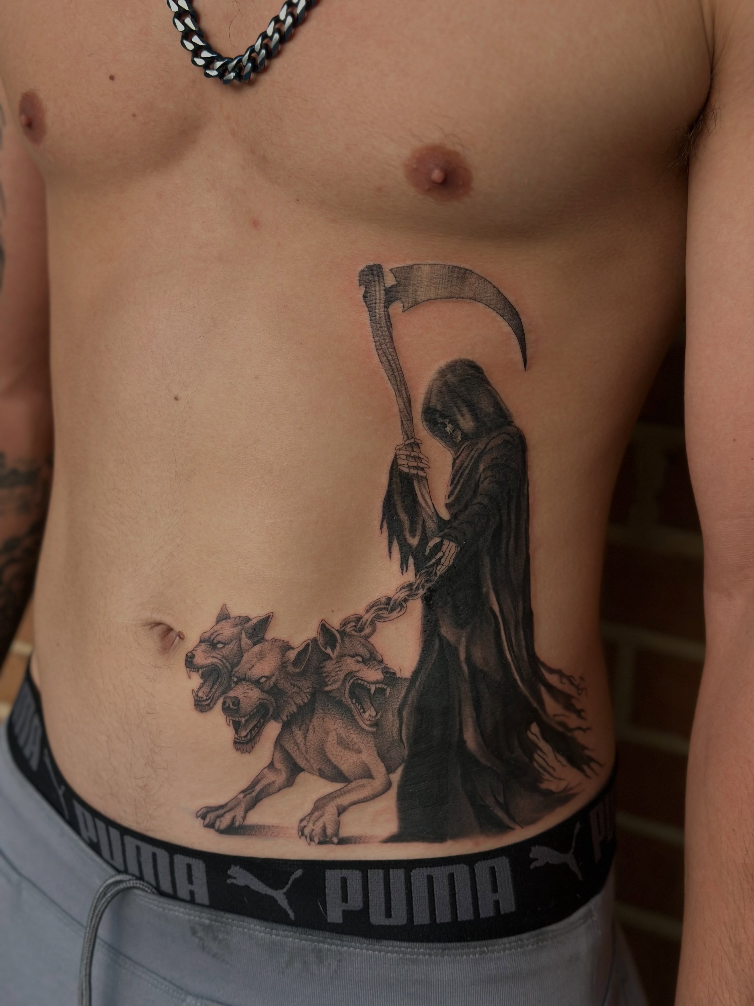 Grim reaper and Cerberus realism tattoo on the ribs by Macy Rae
