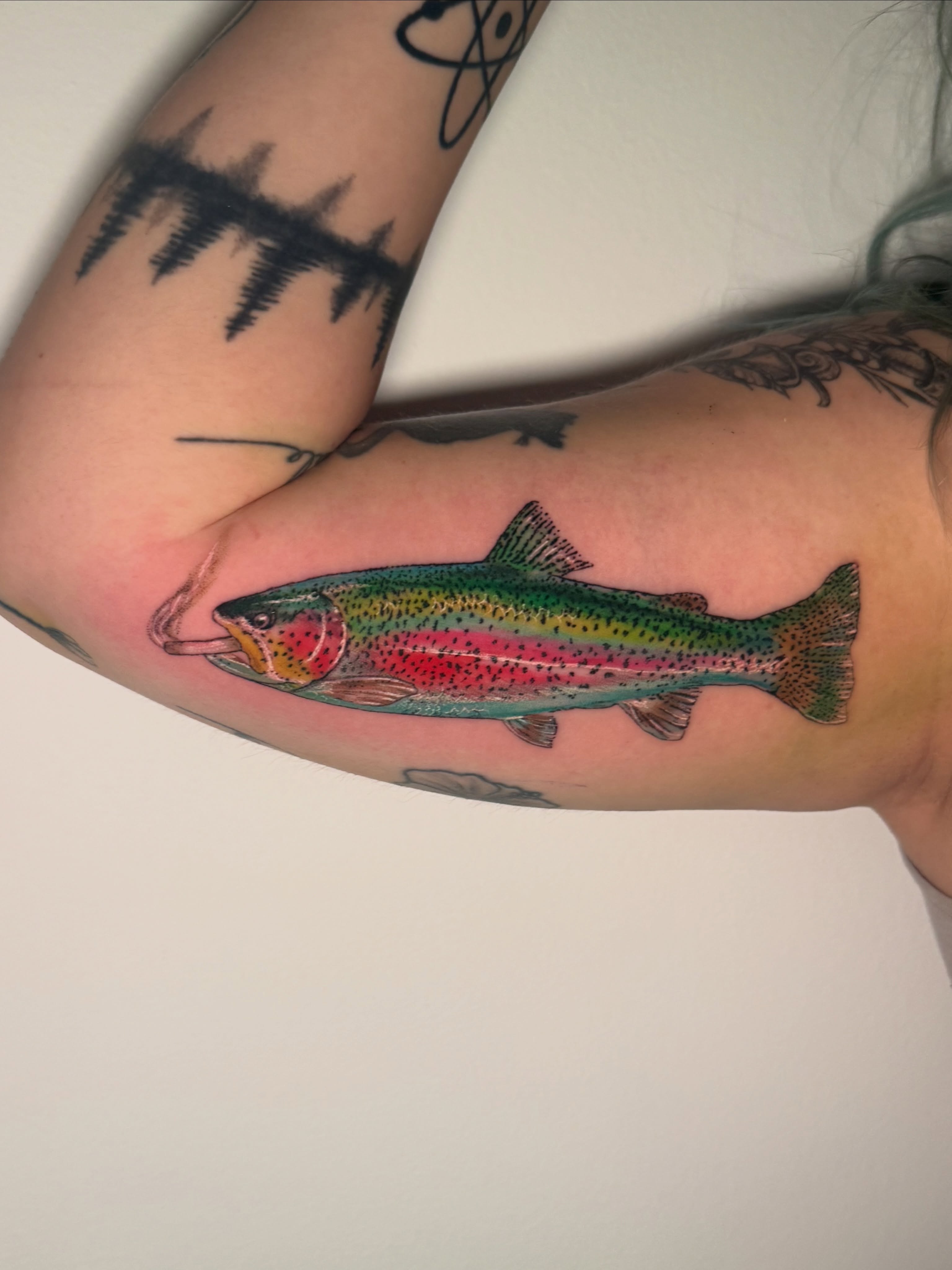 Rainbow trout realism tattoo on the forearm by Asia Rene Tattoos👑