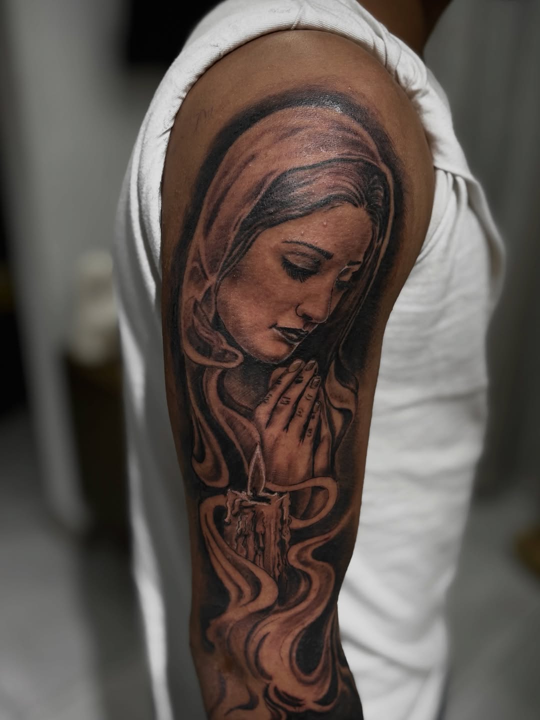 Praying woman with candle Chicano tattoo on the forearm by Mauricio gois