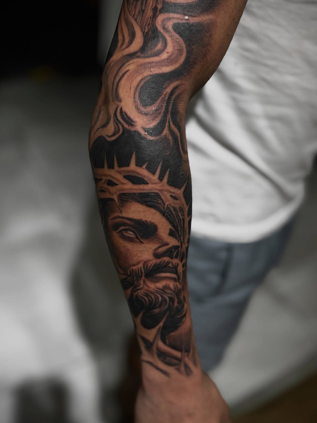 Jesus christ and crown of thorns realism tattoo on the forearm by Mauricio gois