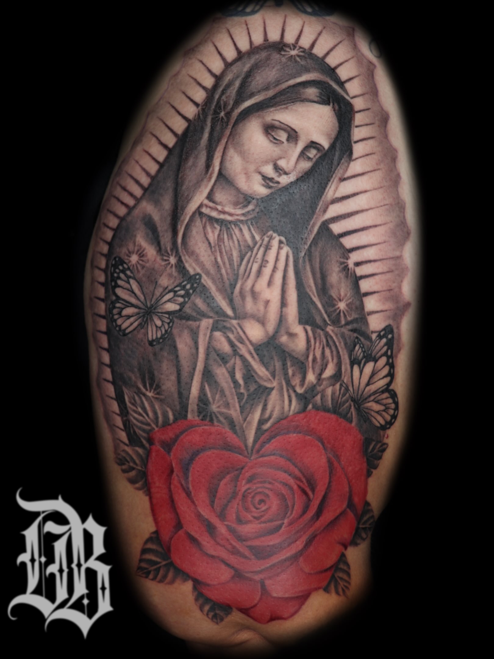 Praying woman with red rose realism tattoo on the forearm by Daniel Rodriguez