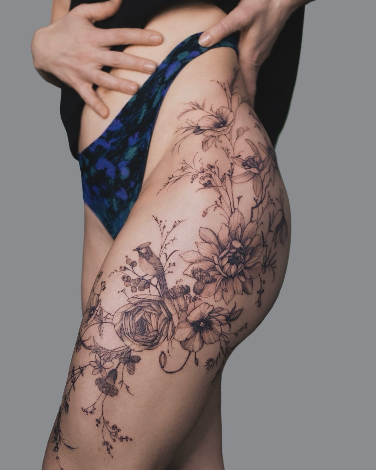 Floral and bird black and grey tattoo on the thigh by Yuliia Babych tattoo AUSTIN