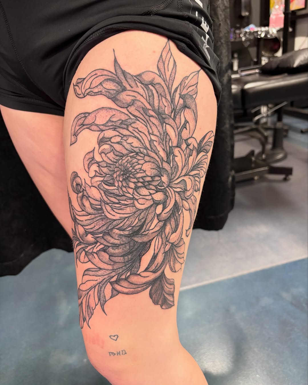 Chrysanthemum dotwork tattoo on the thigh by Tori Anderson, Minneapolis, Minnesota