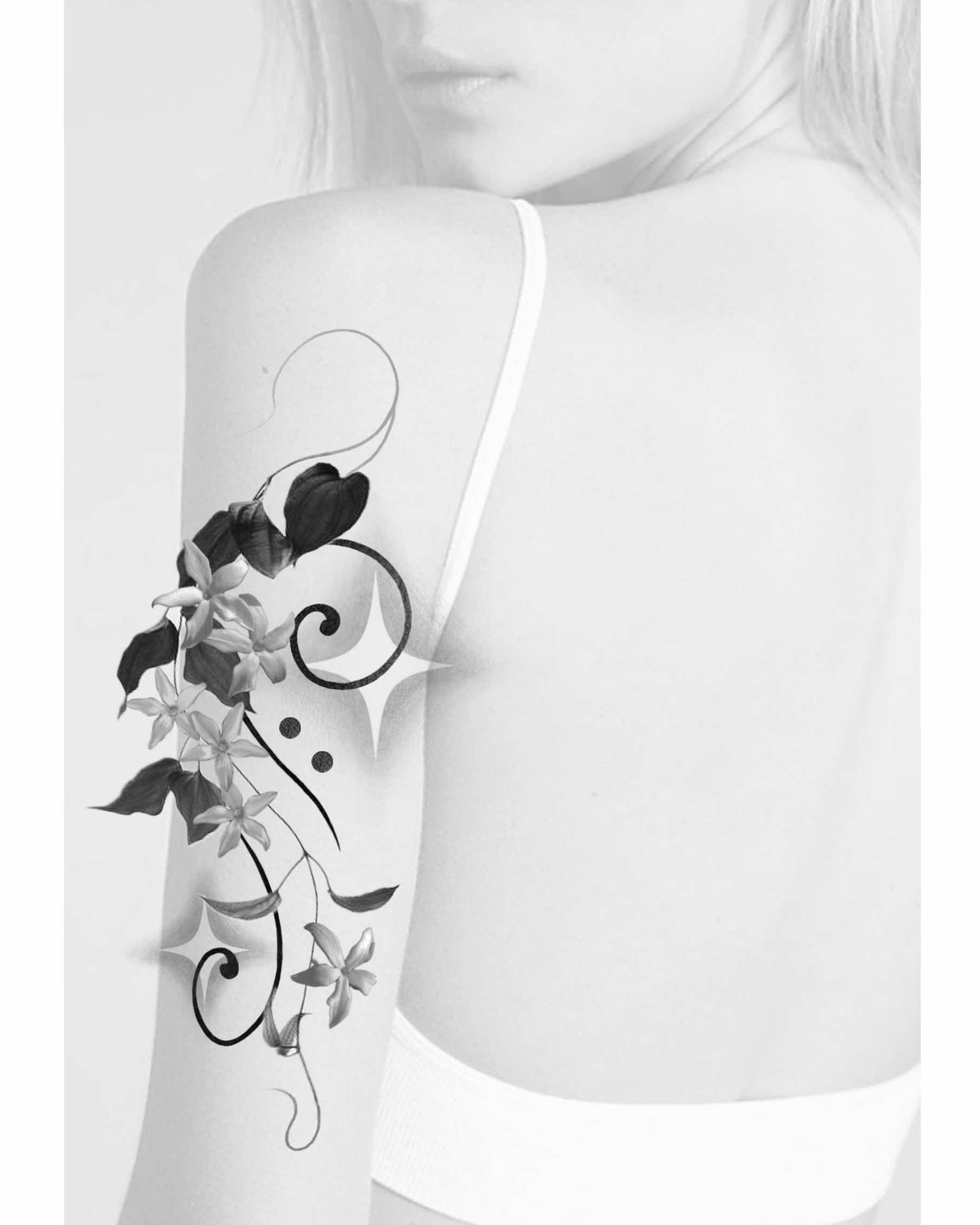 Flower vine ornamental tattoo on the upper arm by Xin Huang