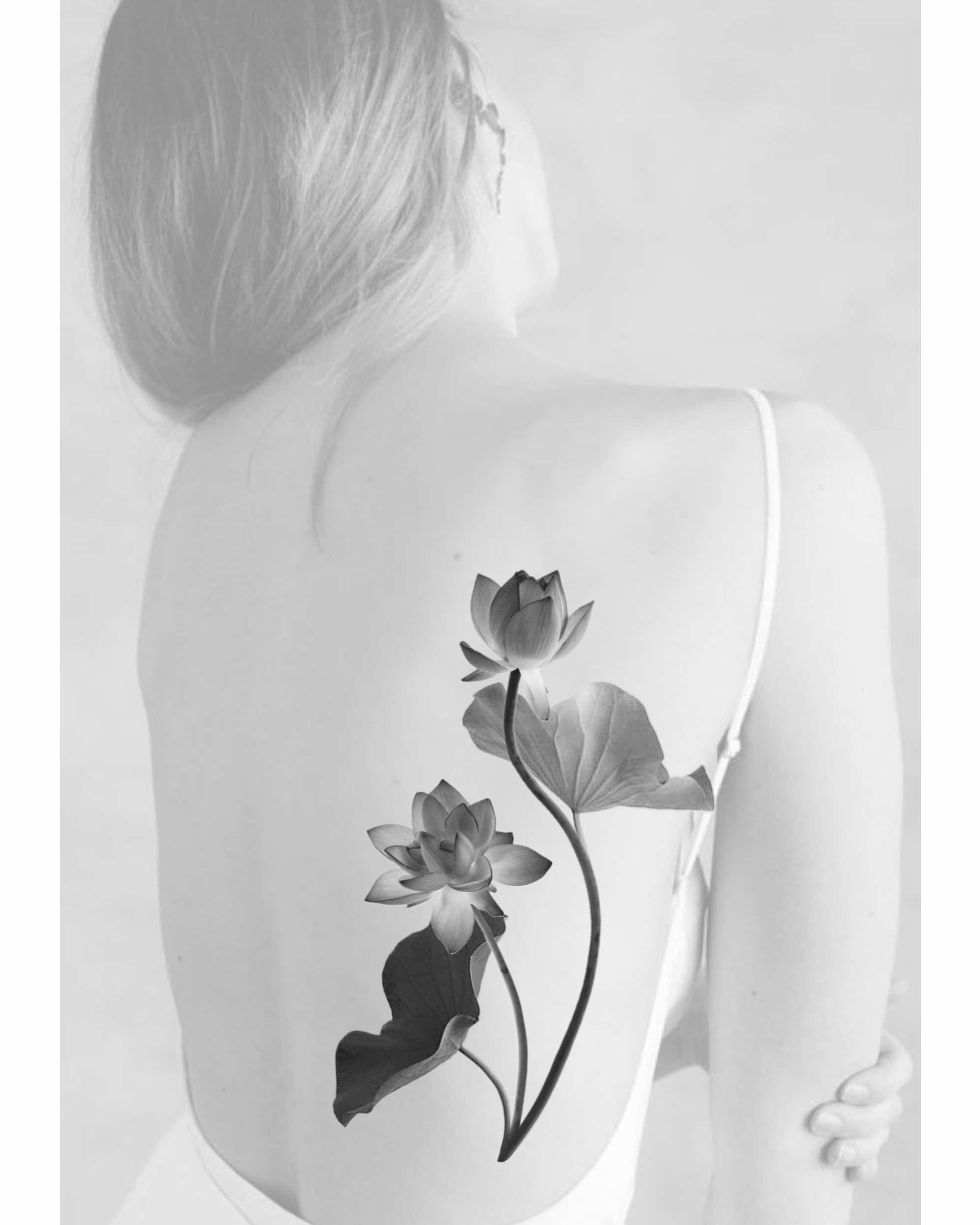 Lotus flowers black and grey tattoo on the back by Xin Huang