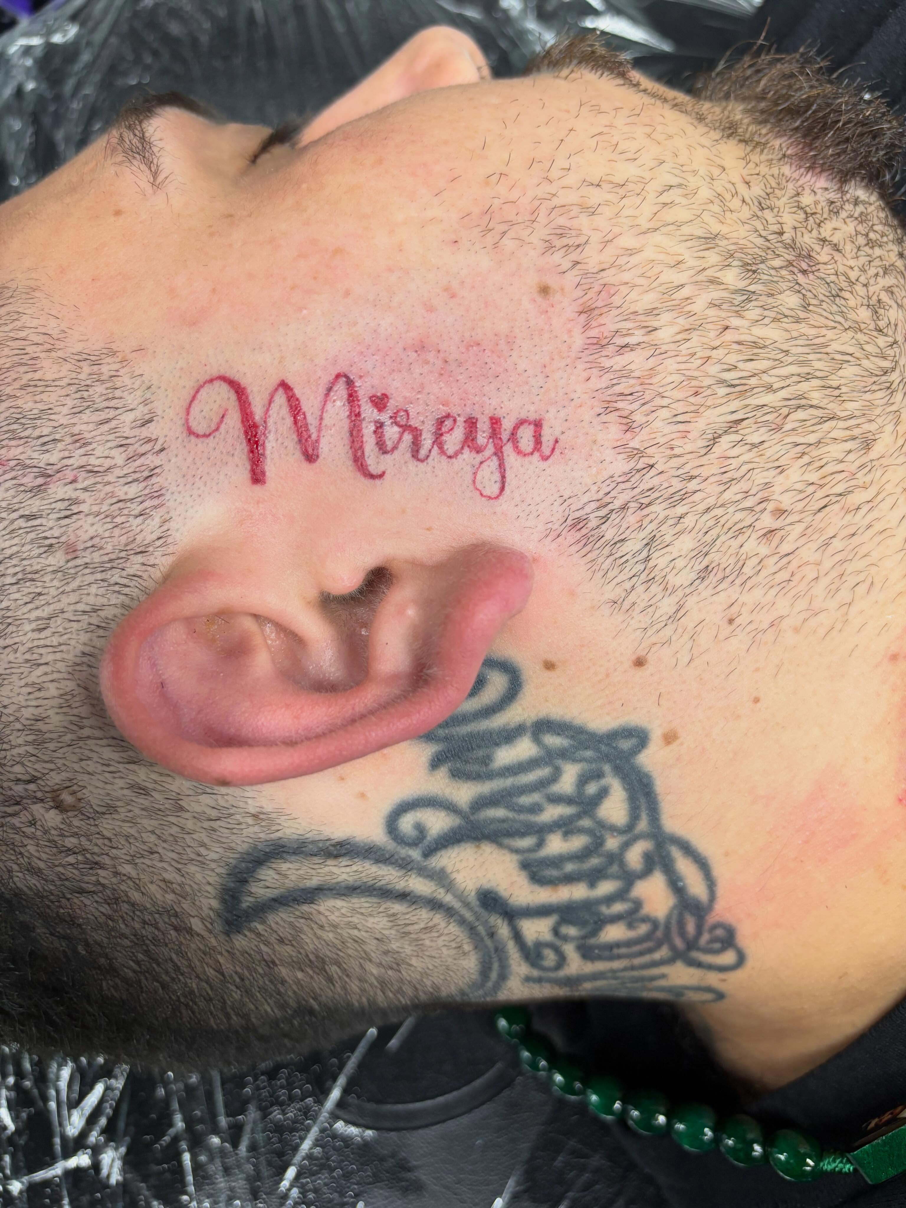 Name tattoo lettering script tattoo on the neck by Shadows Tattoos