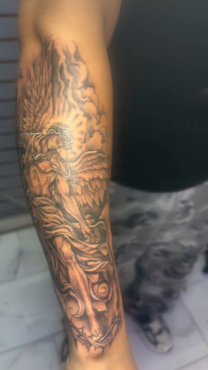Angelic figure with wings realism tattoo on the upper arm by Jose Onasis Disla, New York, New York