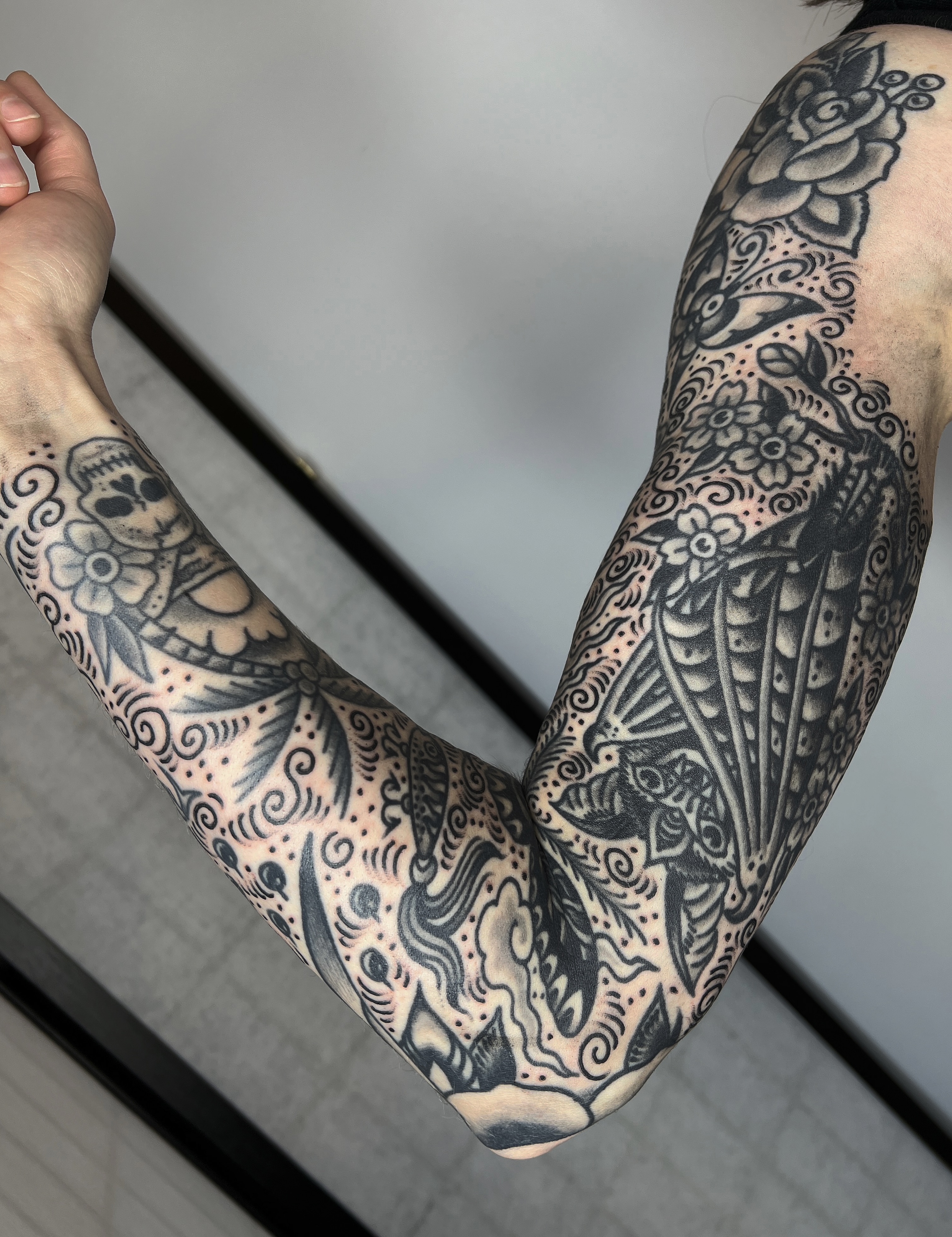 Floral and skeletal motifs ornamental tattoo on the forearm by Leo 🌞 Pdx Tattoo