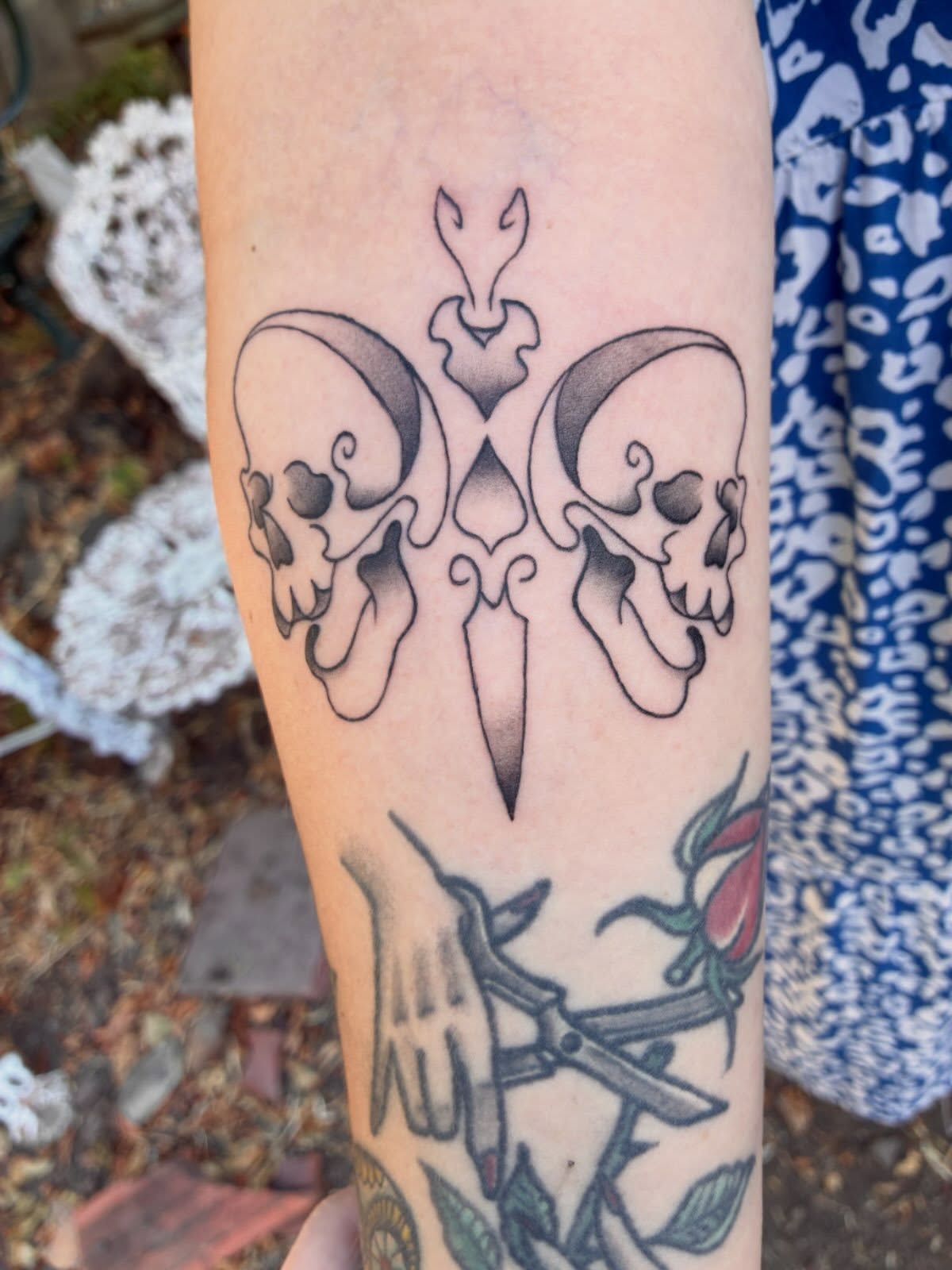 Skulls and dagger black and grey tattoo on the forearm by Xin.H