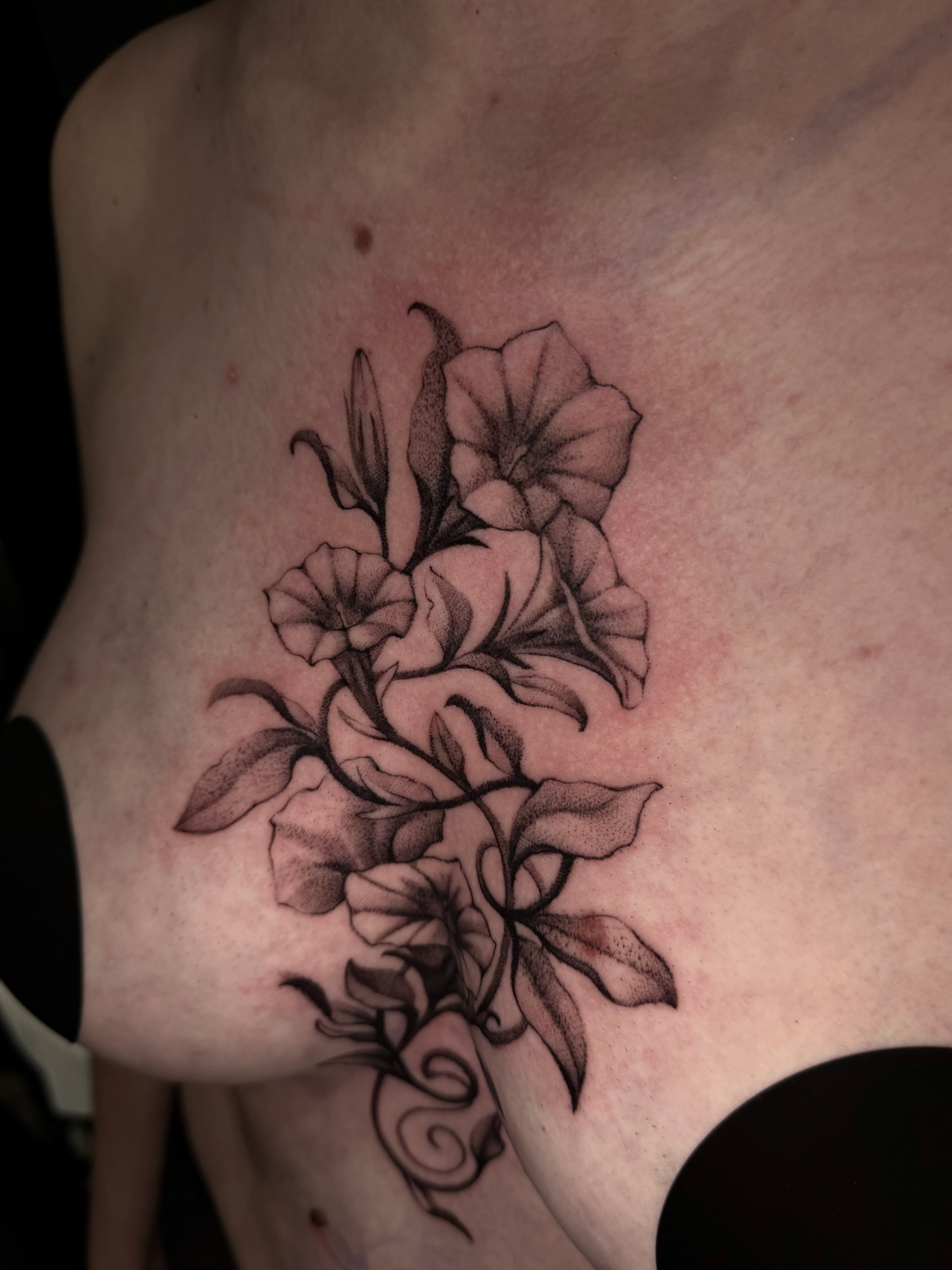 Flowers black and grey tattoo on the chest by Marina Spell