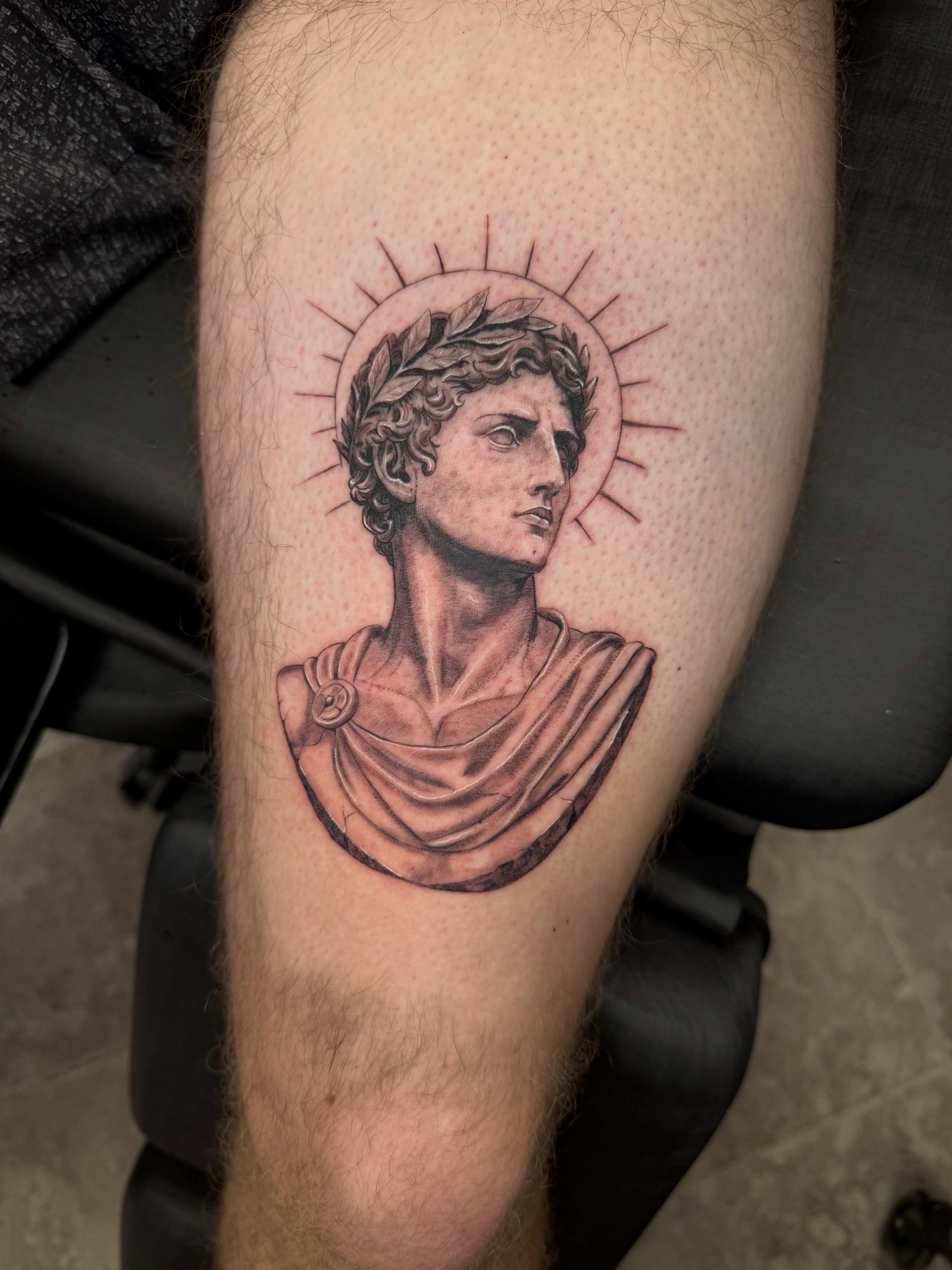 Statue bust black and grey tattoo on the forearm by Juan Guzman
