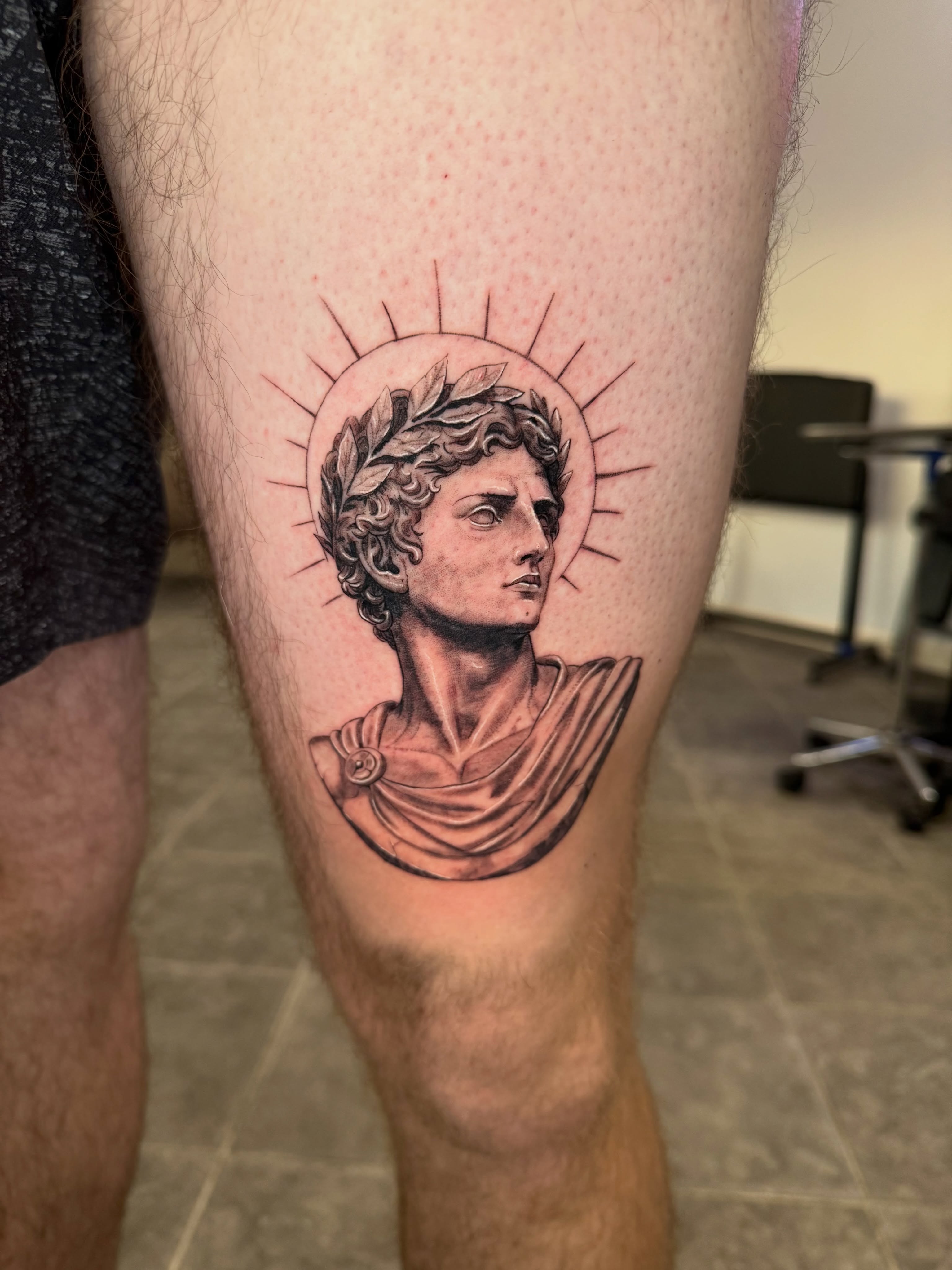 Statue head realism tattoo on the thigh by Juan Guzman
