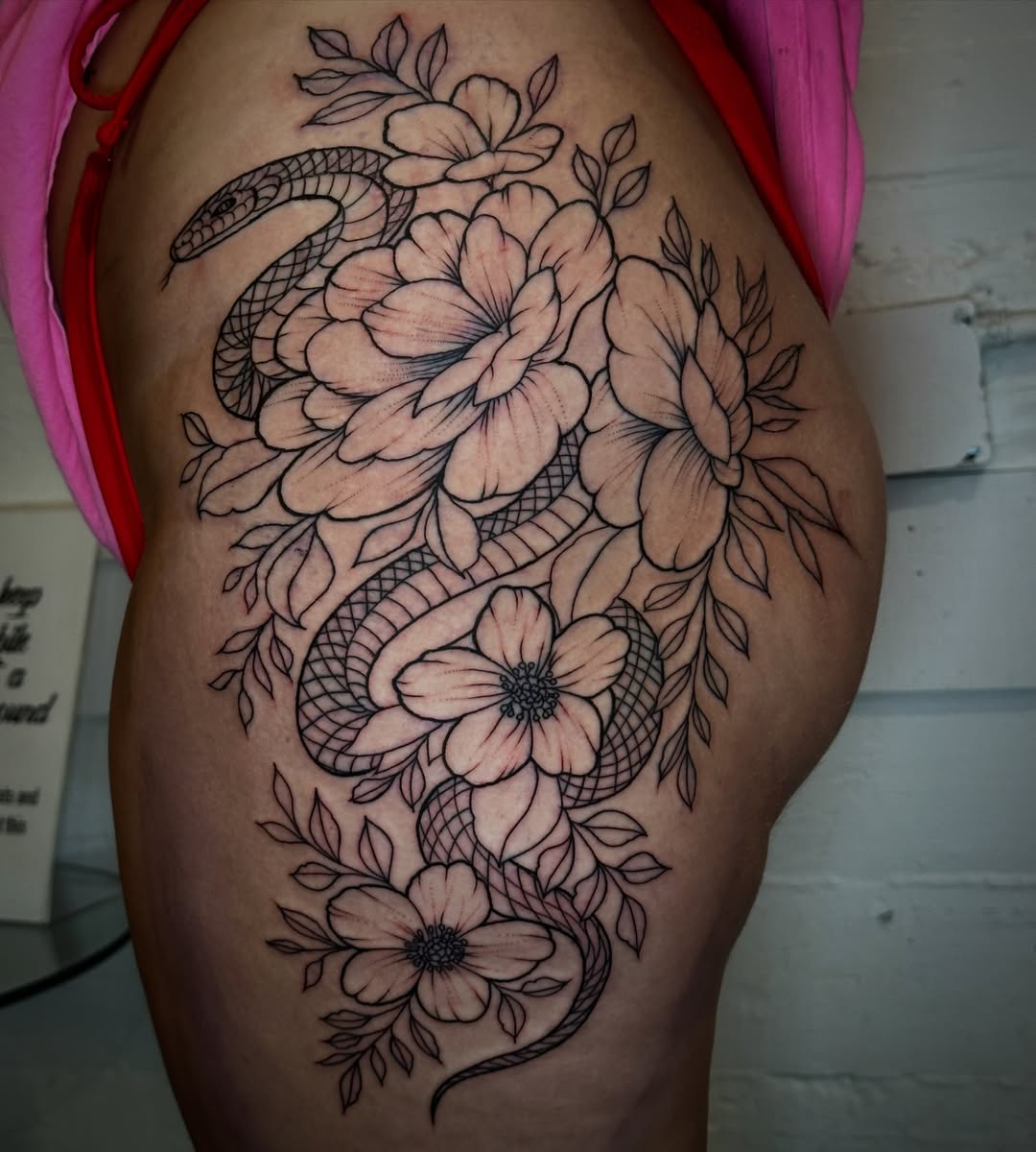 Snake and flowers black and grey tattoo on the thigh by 𝕳𝖆𝖓𝖓𝖆𝖍 𝕮𝖆𝖓𝖋𝖎𝖊𝖑𝖉 ✨ Memphis Tattoo Artist, Memphis, Tennessee