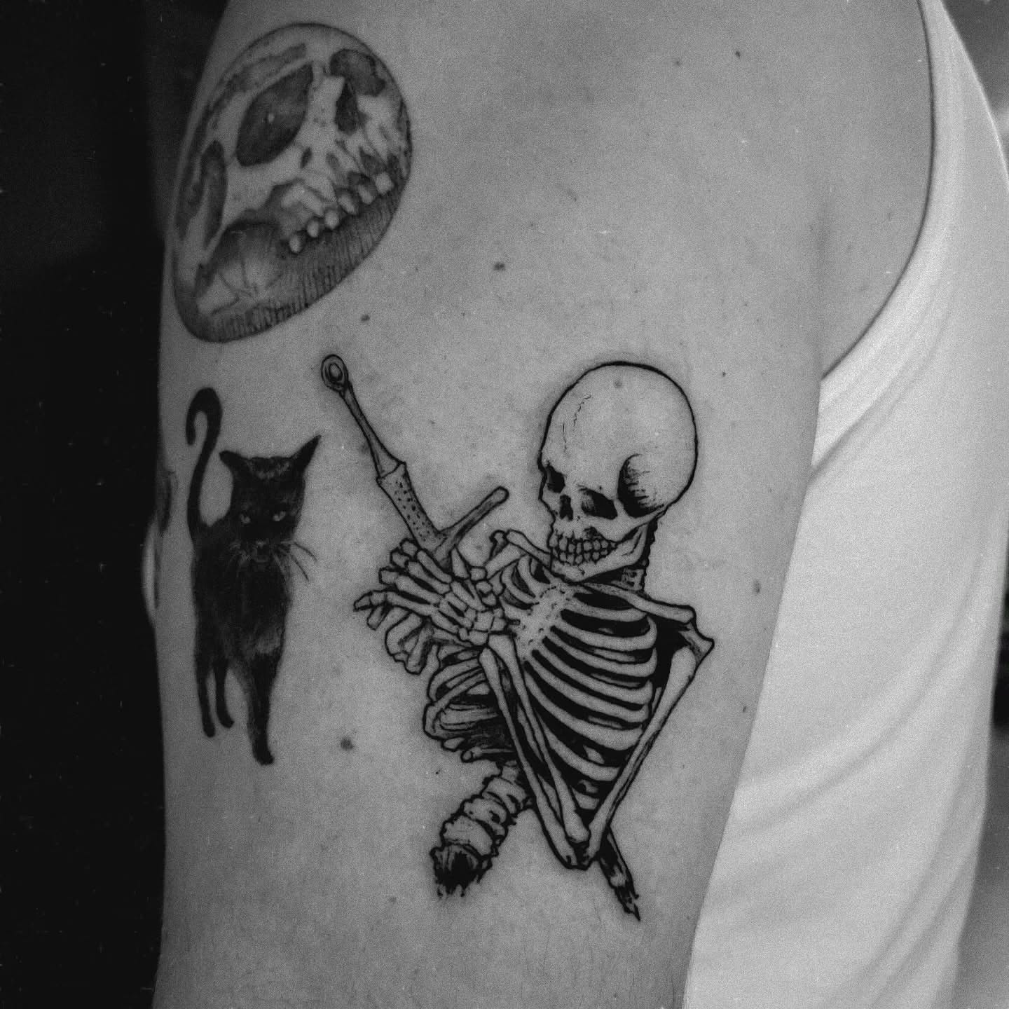 Skeleton playing violin realism tattoo on the forearm by Nathan Harkins-Oberbeck