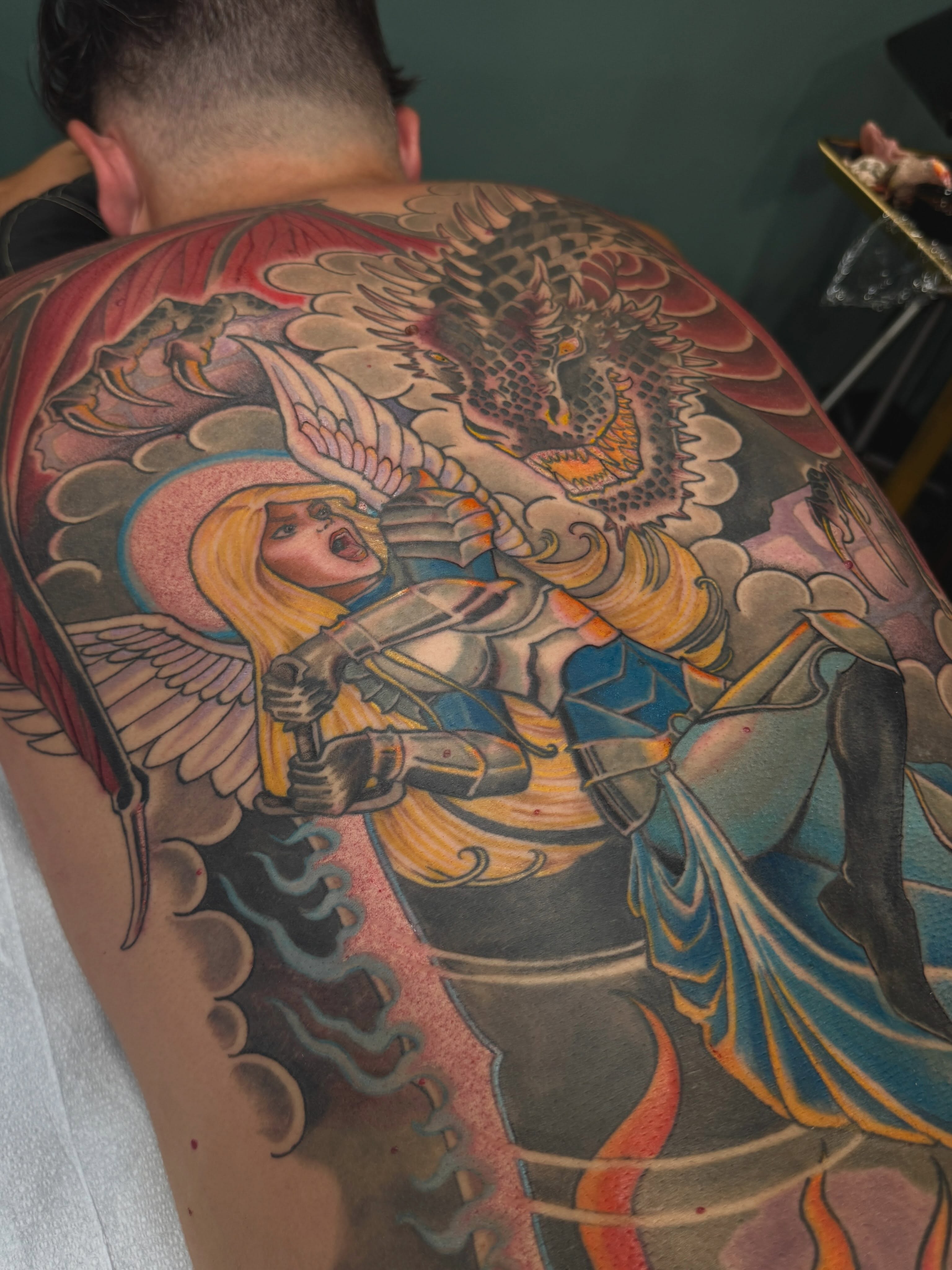 Angel and dragon American traditional tattoo on the back by English Cousins, Nashville, Tennessee