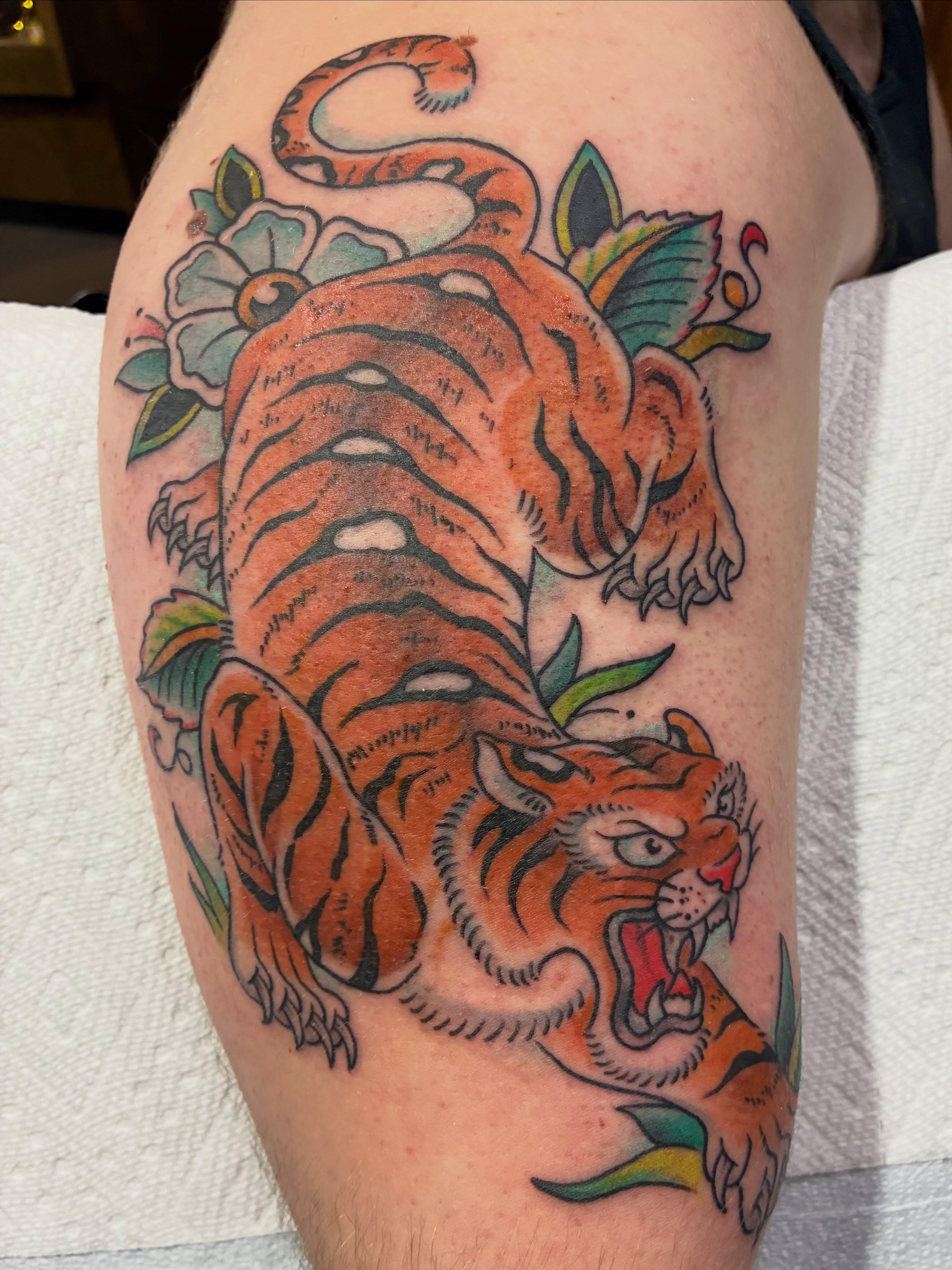 Tiger American traditional tattoo on the thigh by Natalie Spuhler