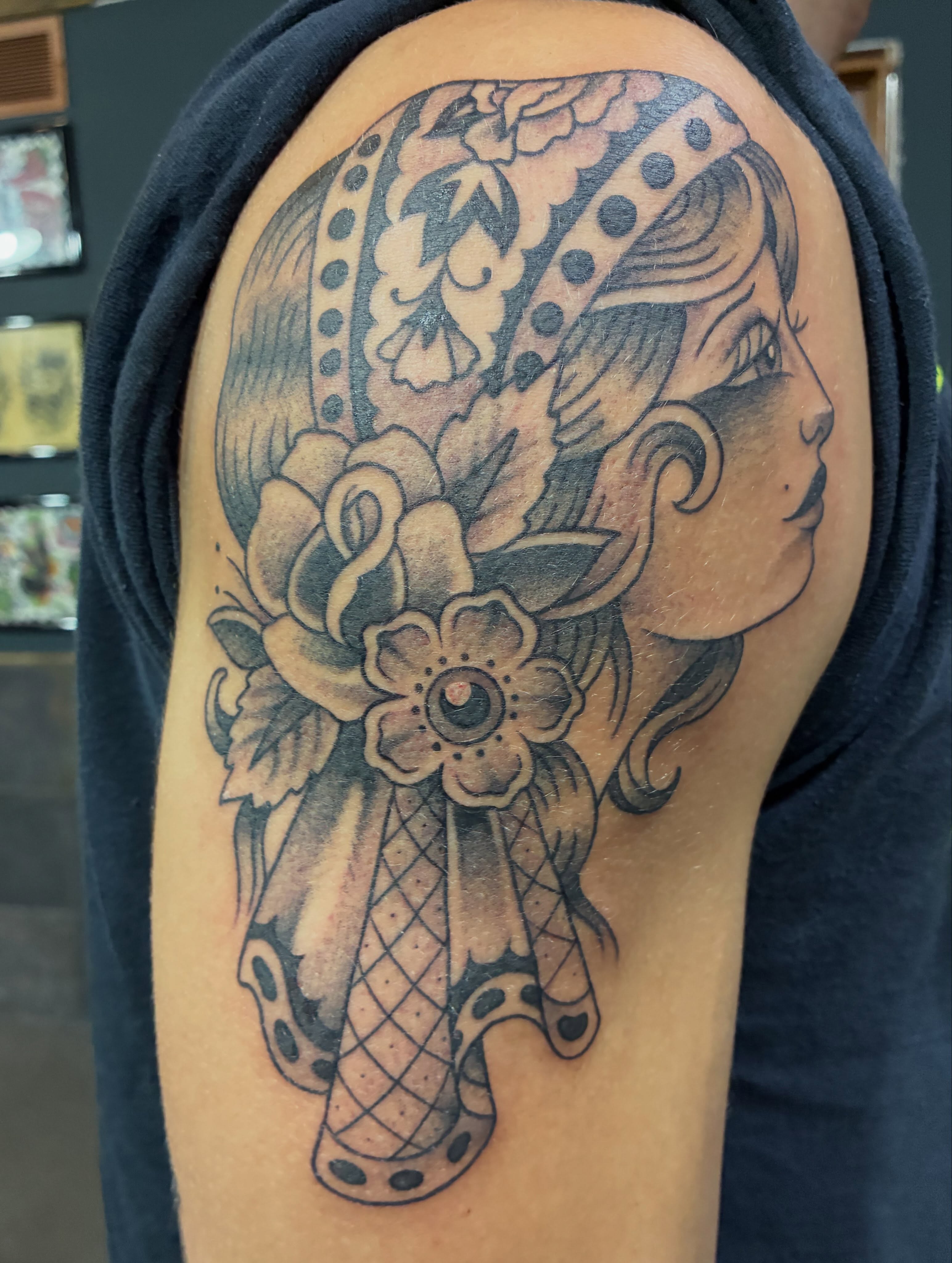 Woman with floral headdress American traditional tattoo on the shoulder by Natalie Spuhler