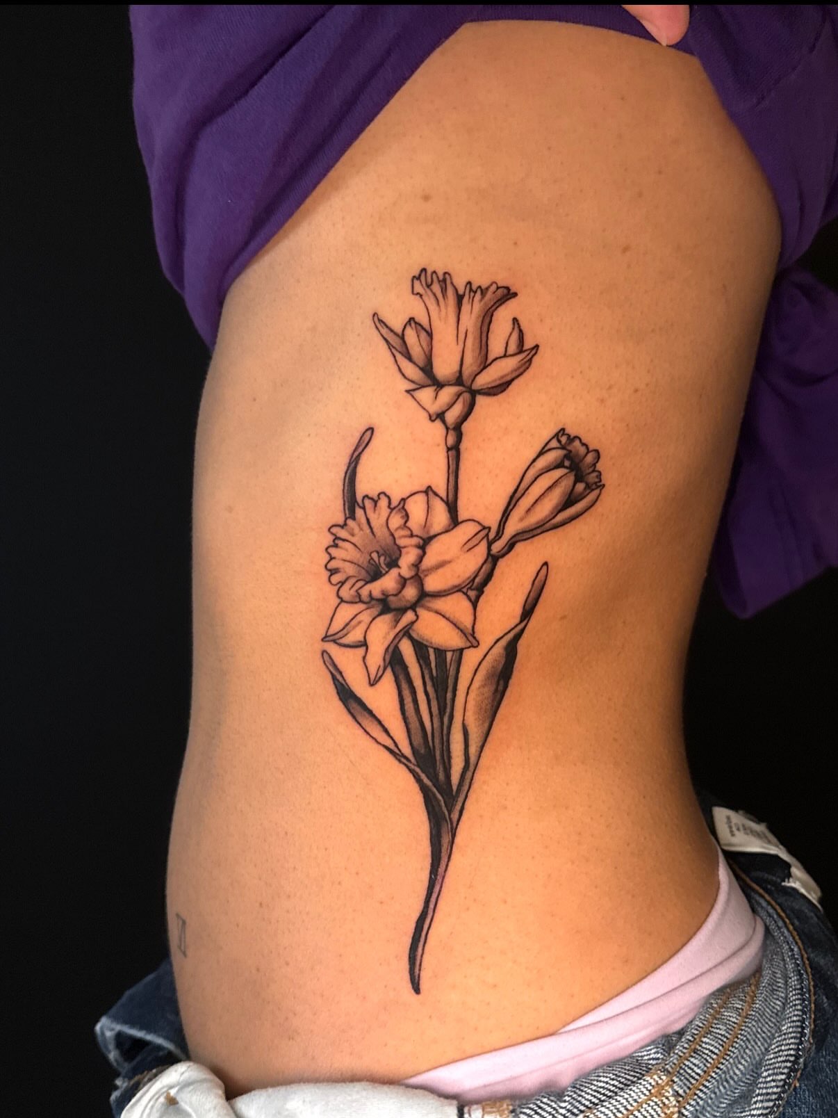 Daffodil bouquet black and grey tattoo on the ribs by marlena borscheid