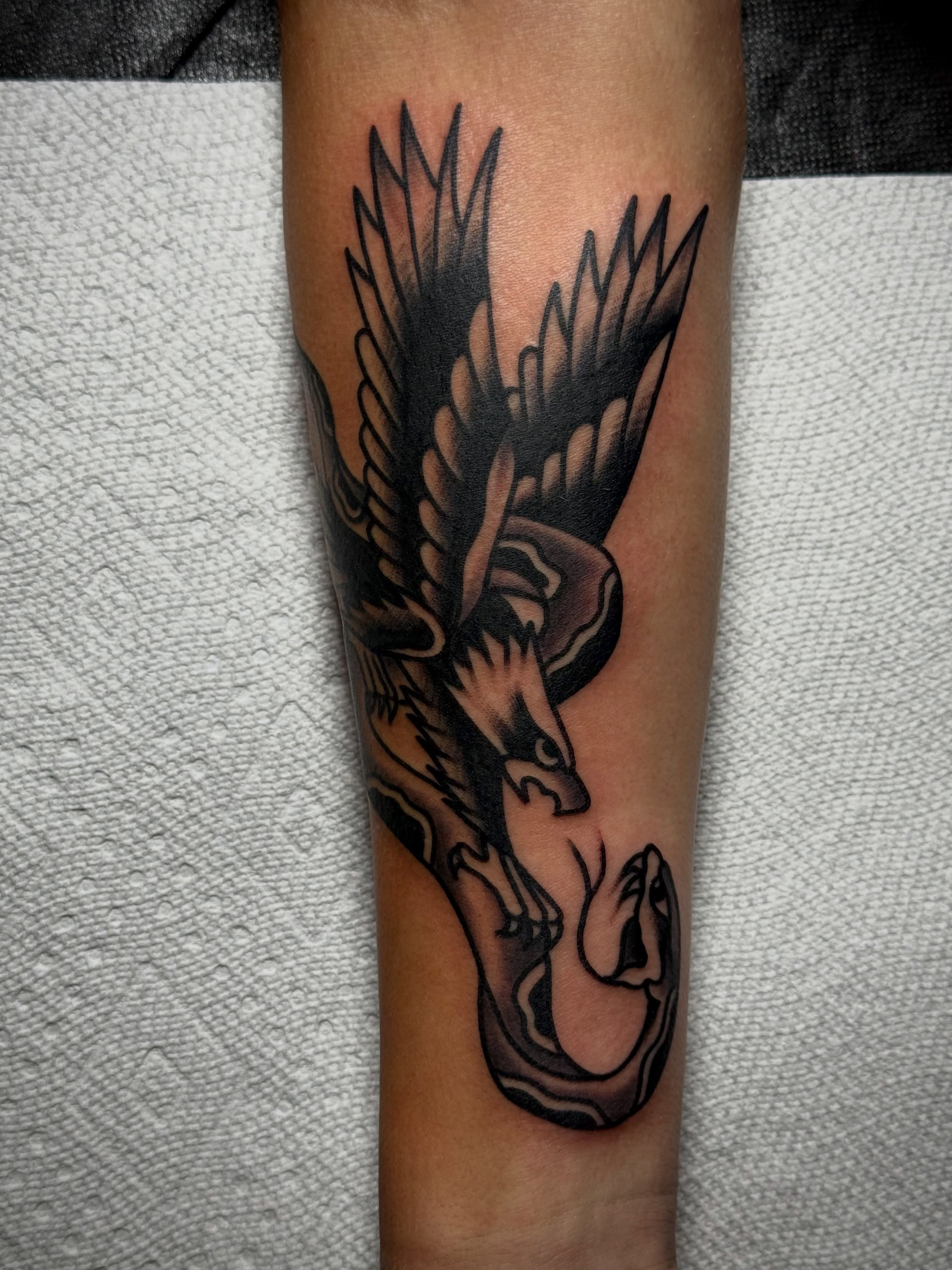 Eagle black and grey tattoo on the forearm by Chuck Derek Whitaker