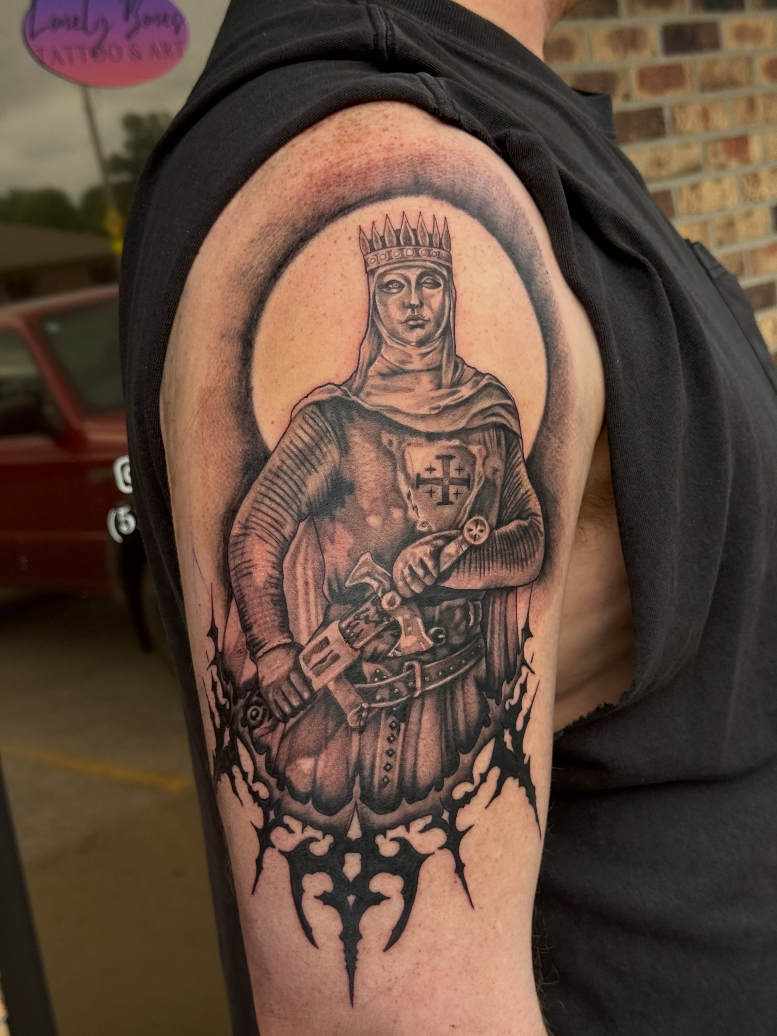 Knight realism tattoo on the upper arm by Lauren Horness