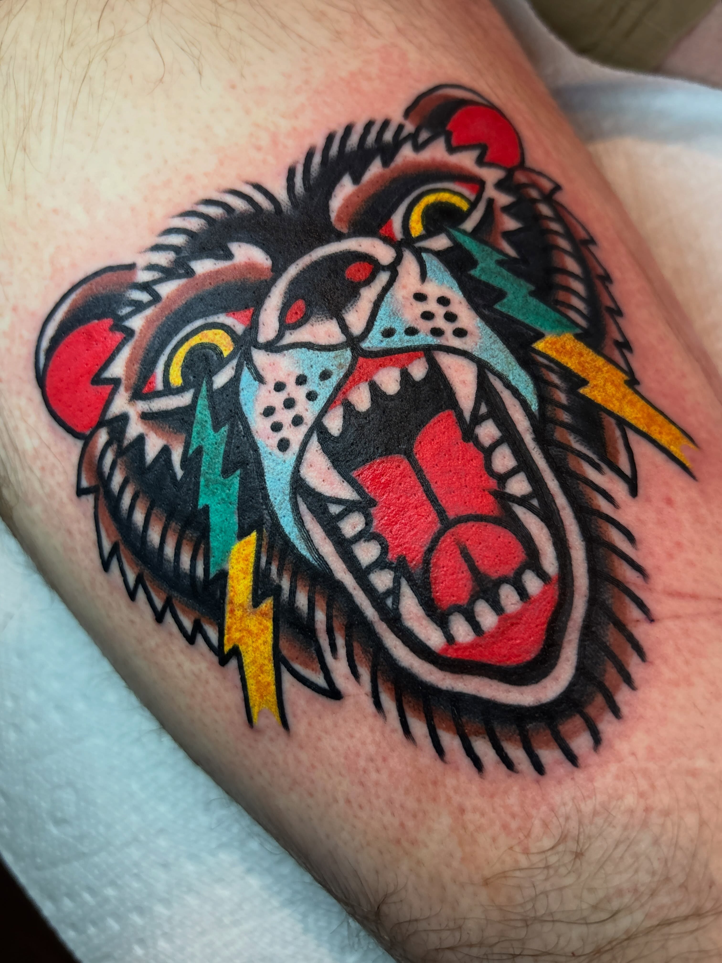 Roaring bear American traditional tattoo on the thigh by Mitch Ashpaugh