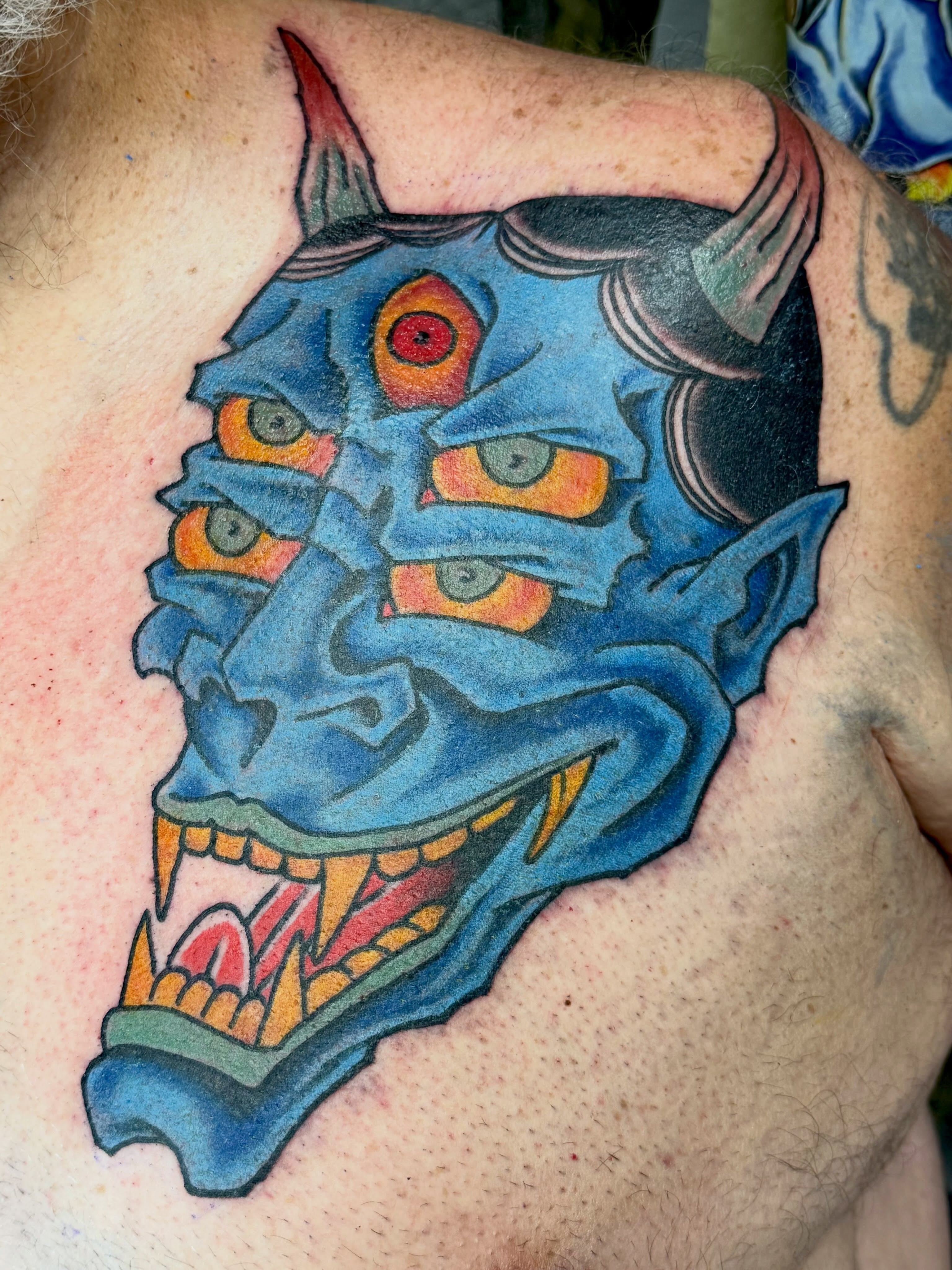 Demon mask American traditional tattoo on the chest by KevinBetsch