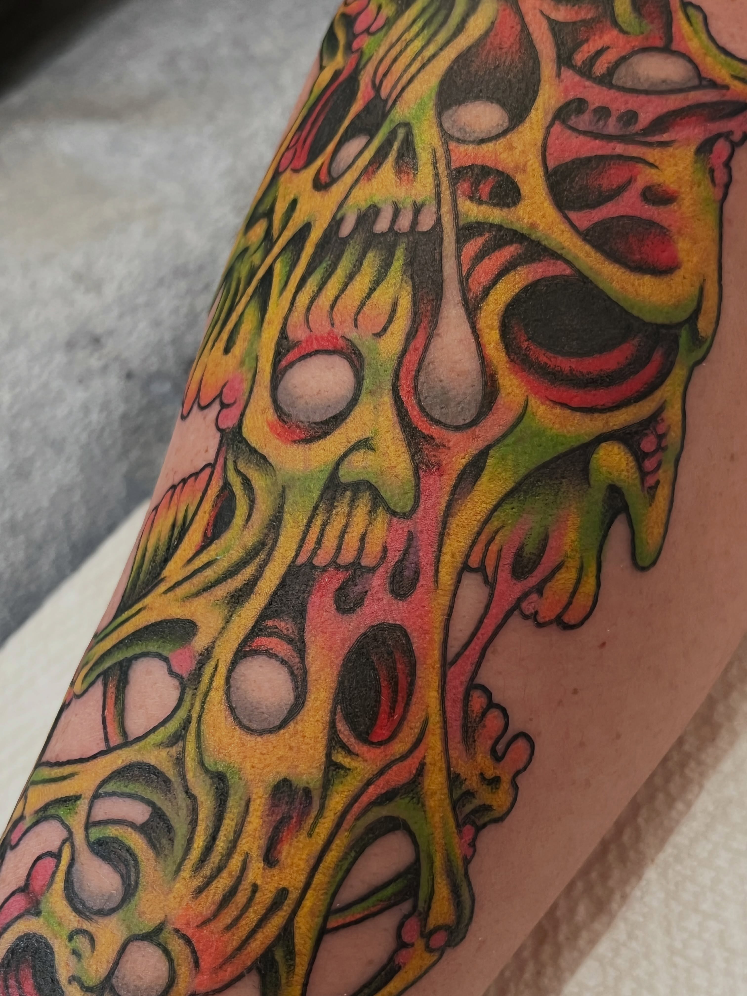 Melting skull surrealism tattoo on the forearm by Campbell Zane Alexander
