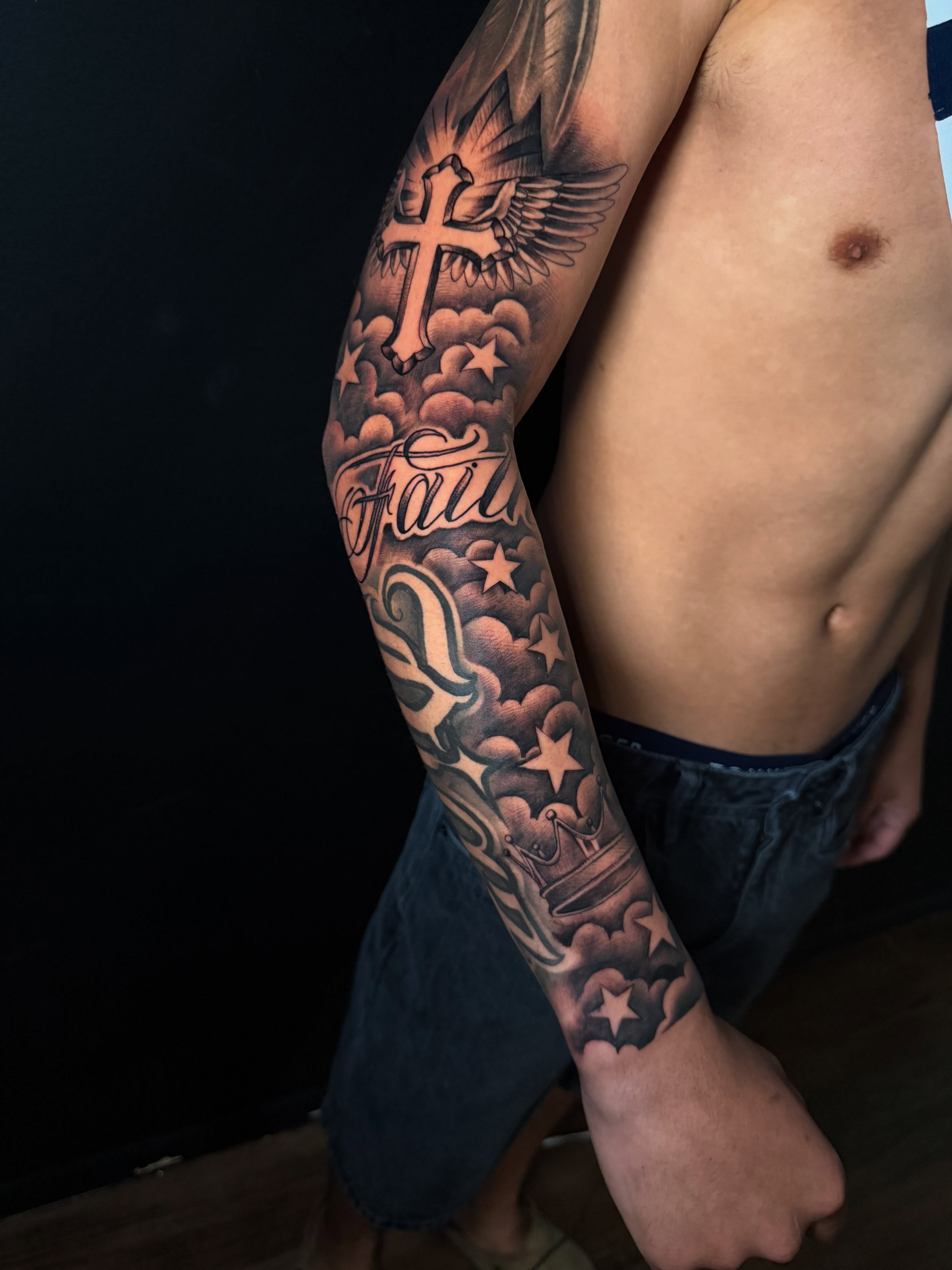 Cross and clouds black and grey tattoo on the forearm by George Maldonado Austin, Austin, Texas
