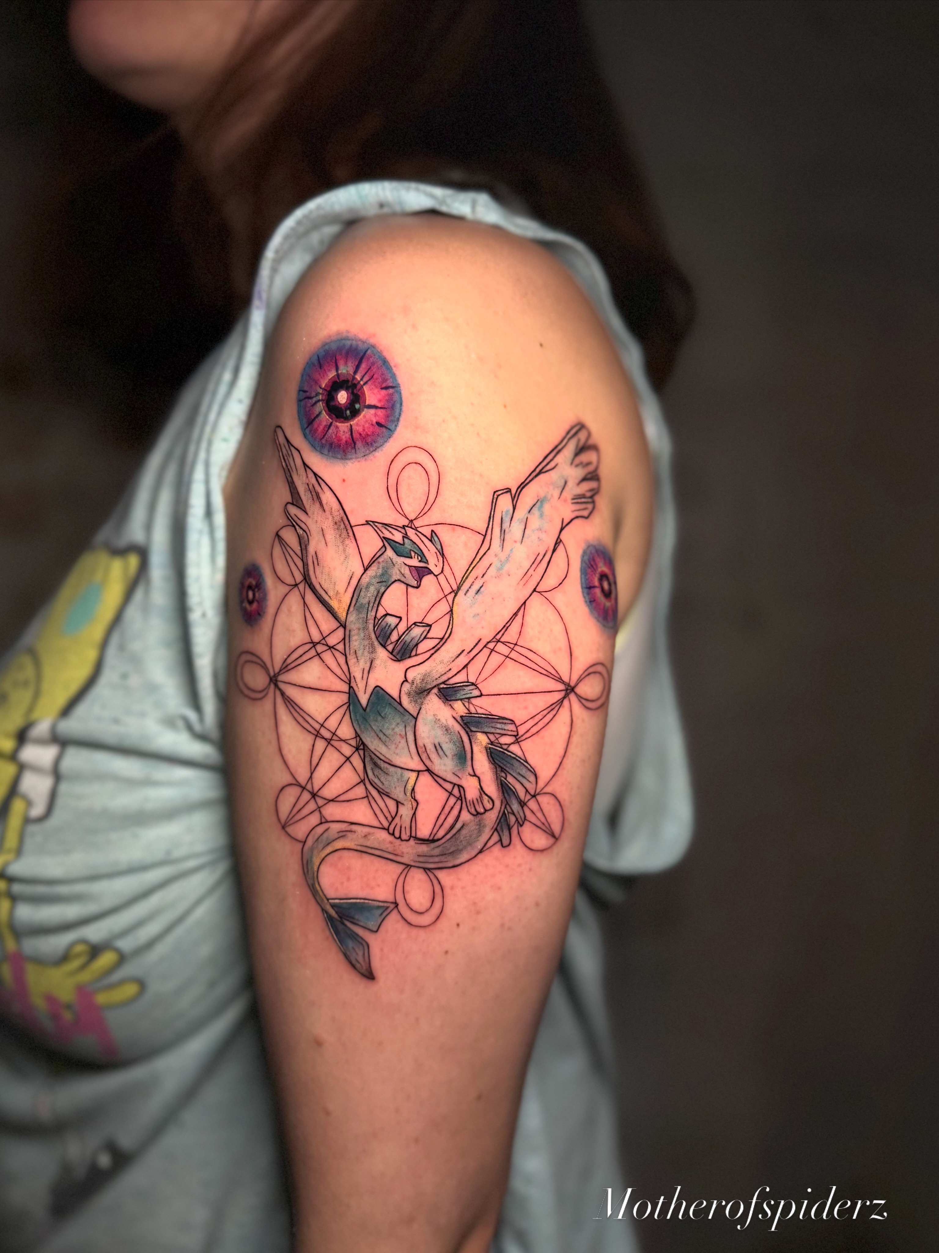 Dragon geometric tattoo on the shoulder by Alyssa Garza