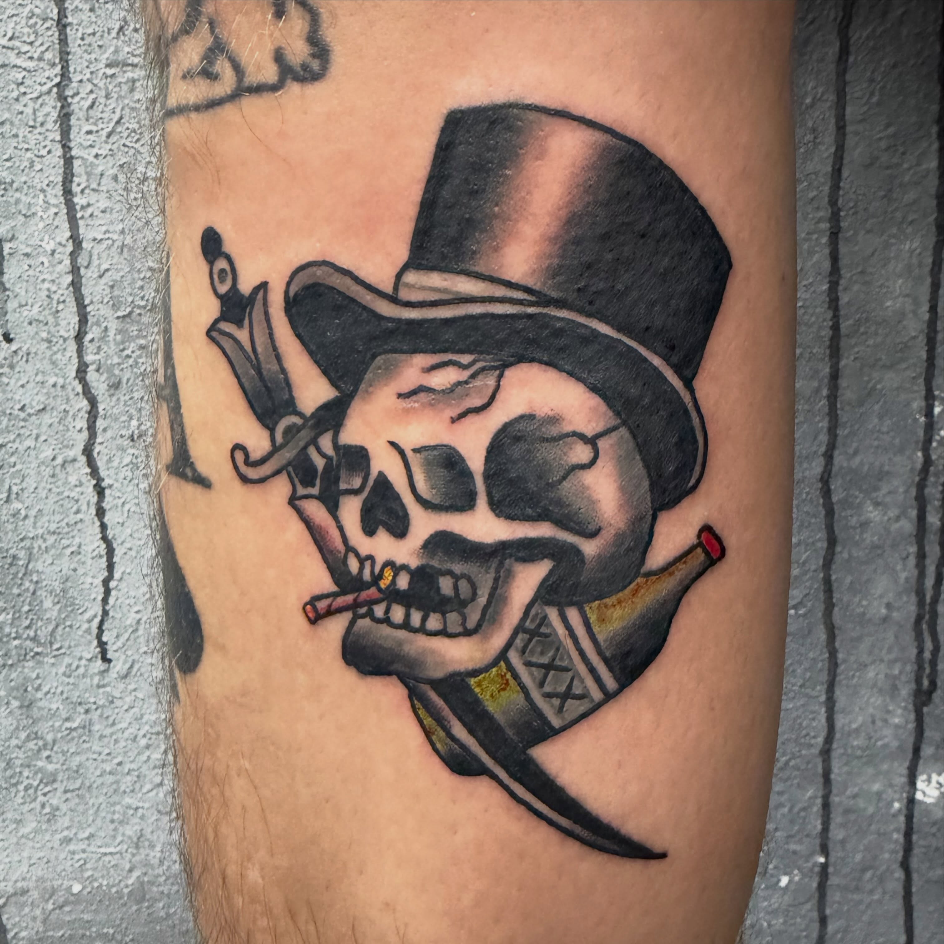 Skull with top hat American traditional tattoo on the forearm by Camilo