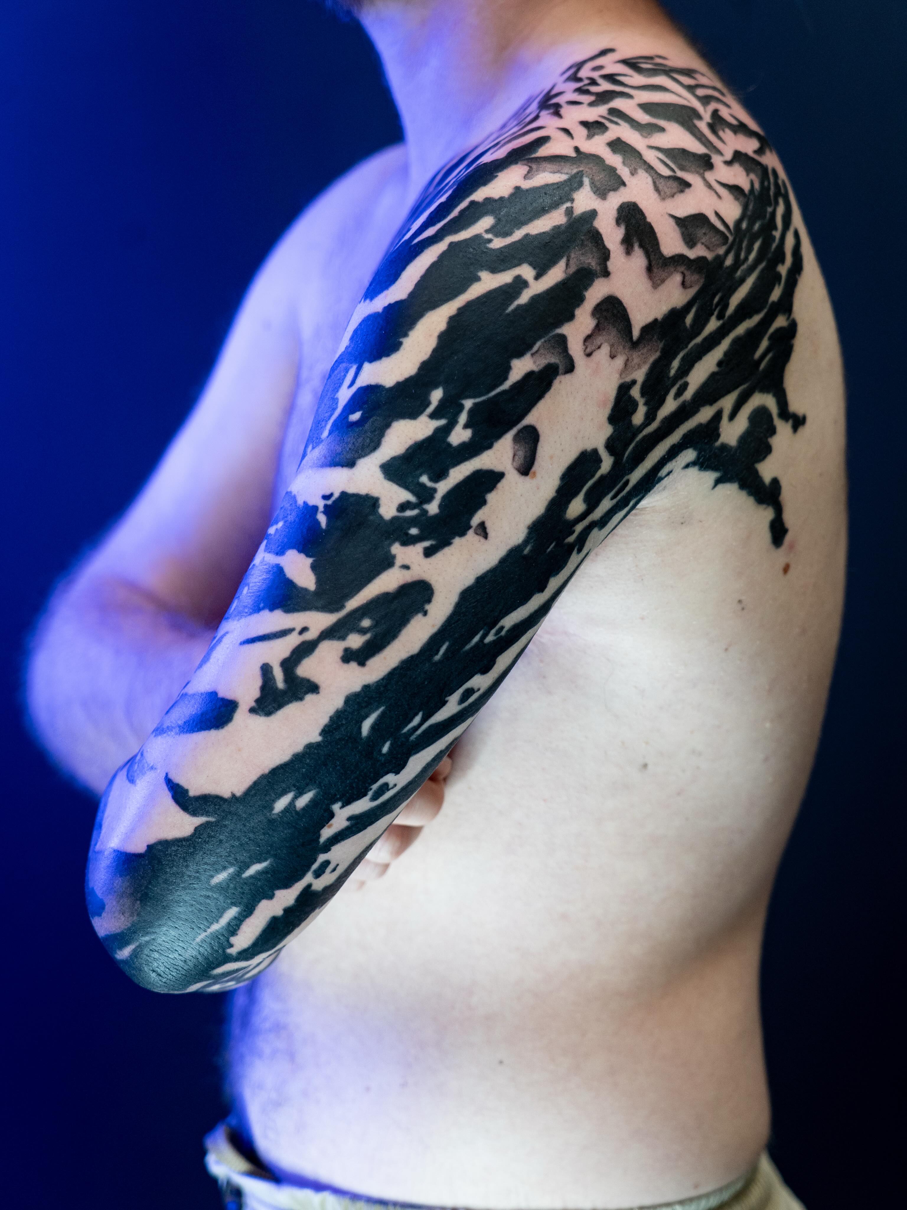 Abstract pattern black and grey tattoo on the upper arm by Josaline Green