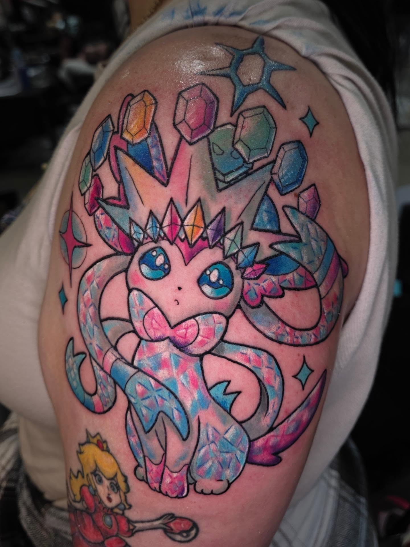 Jeweled creature geometric tattoo on the shoulder by Kayla Williams