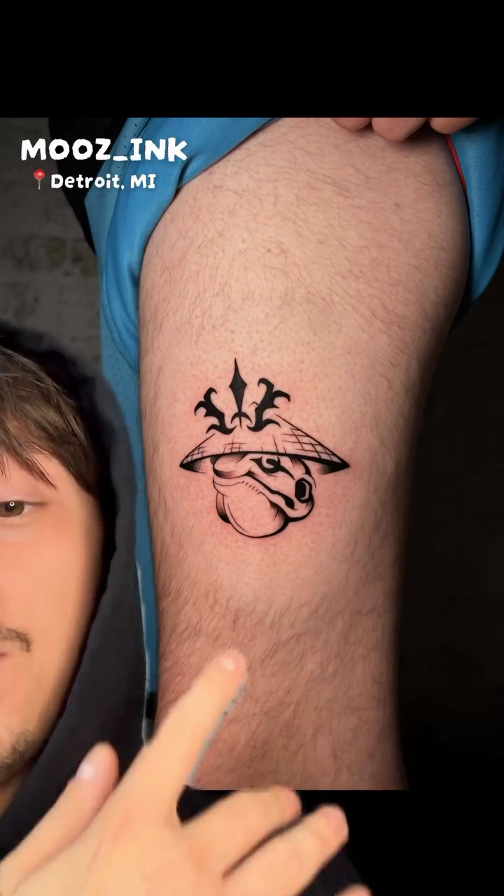 Stylized creature head blackwork tattoo by Musa Selman