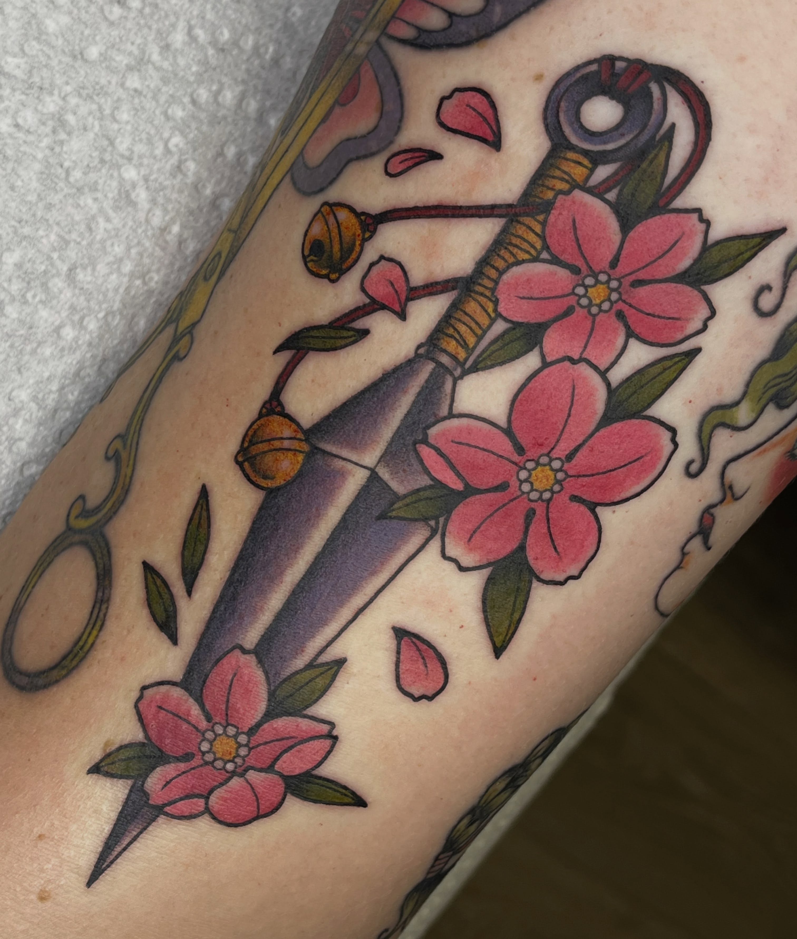 Cherry blossoms and sword American traditional tattoo on the forearm by Lance 🦈