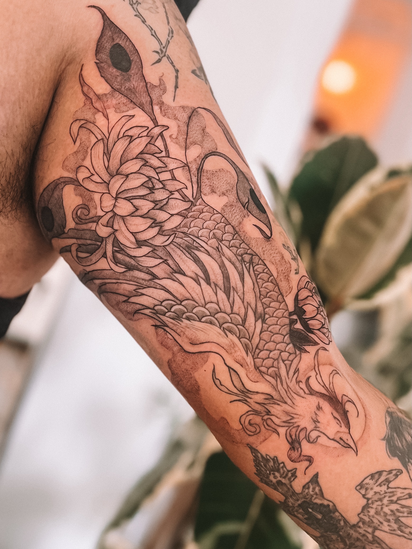 Koi fish and chrysanthemum black and grey tattoo on the forearm by sebs phạm, Los Angeles, California