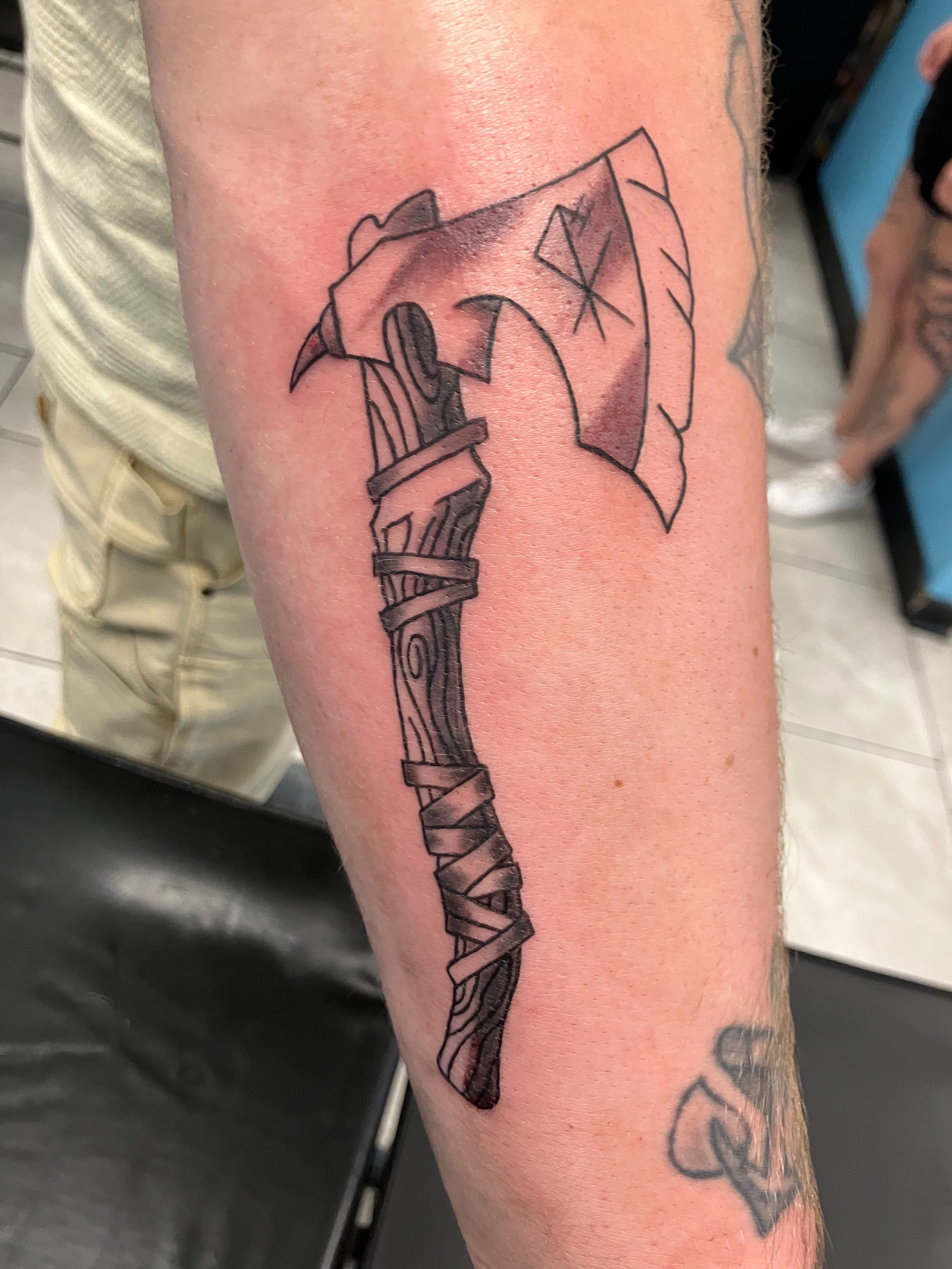 Ax black and grey tattoo on the forearm by Bryant Johnson