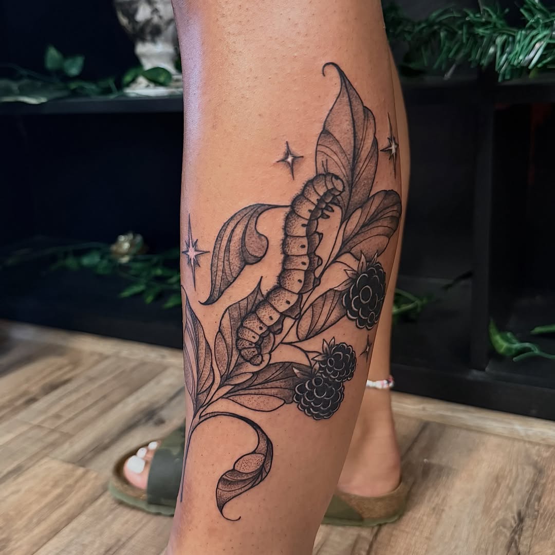 Caterpillar and berries black and grey tattoo on the calf by Haley Bates