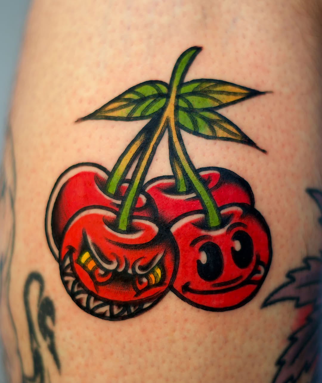Cherries American traditional tattoo on the thigh by Tattooer Sancho 🇰🇷🇨🇦