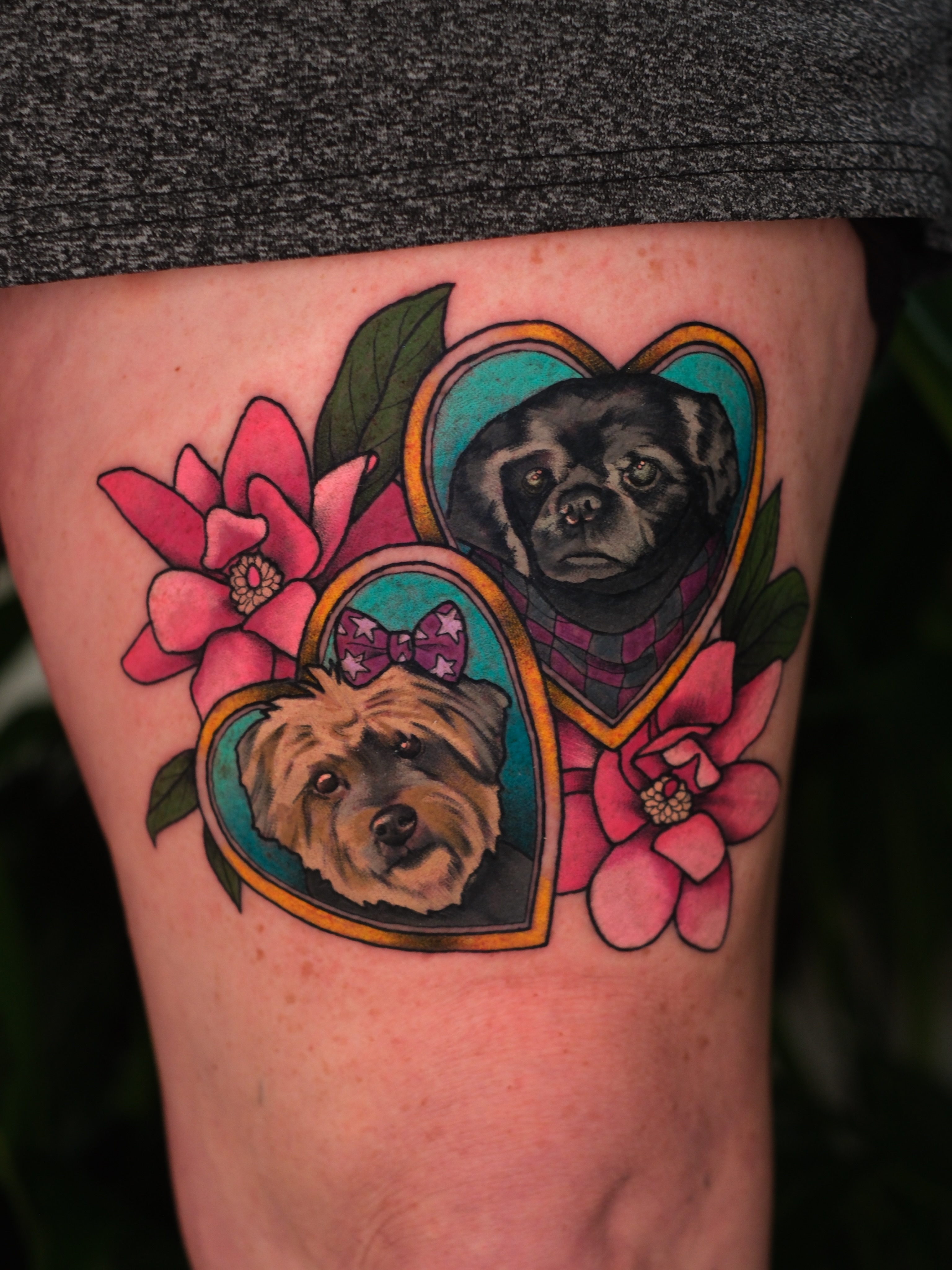 Dogs and flowers realism tattoo on the thigh by Mallory Murphy, Denton, Texas