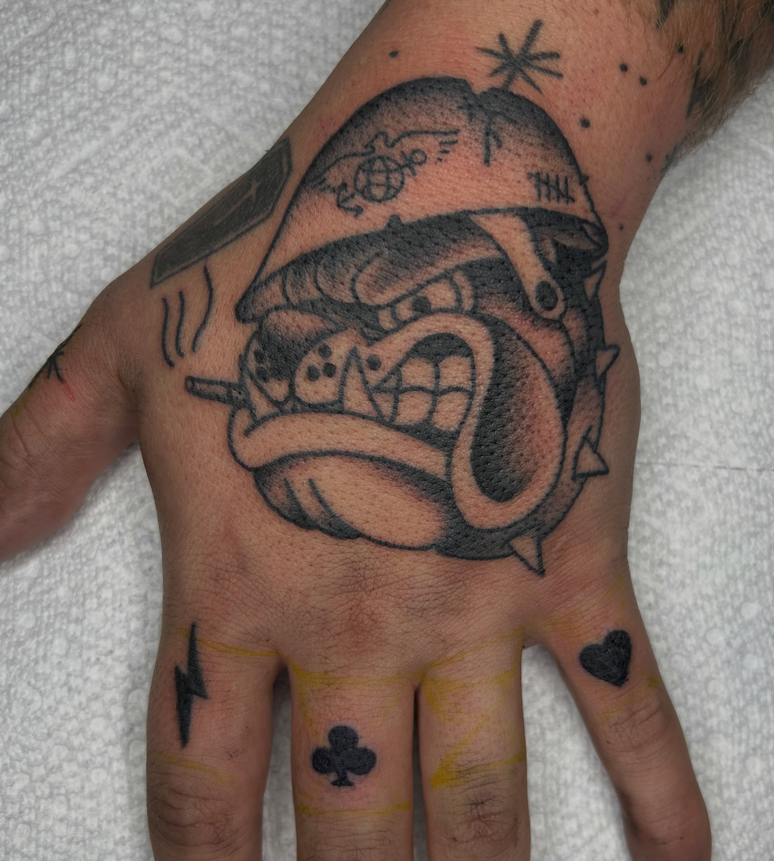 Bulldog wearing helmet American traditional tattoo on the hand by Zach Andrews