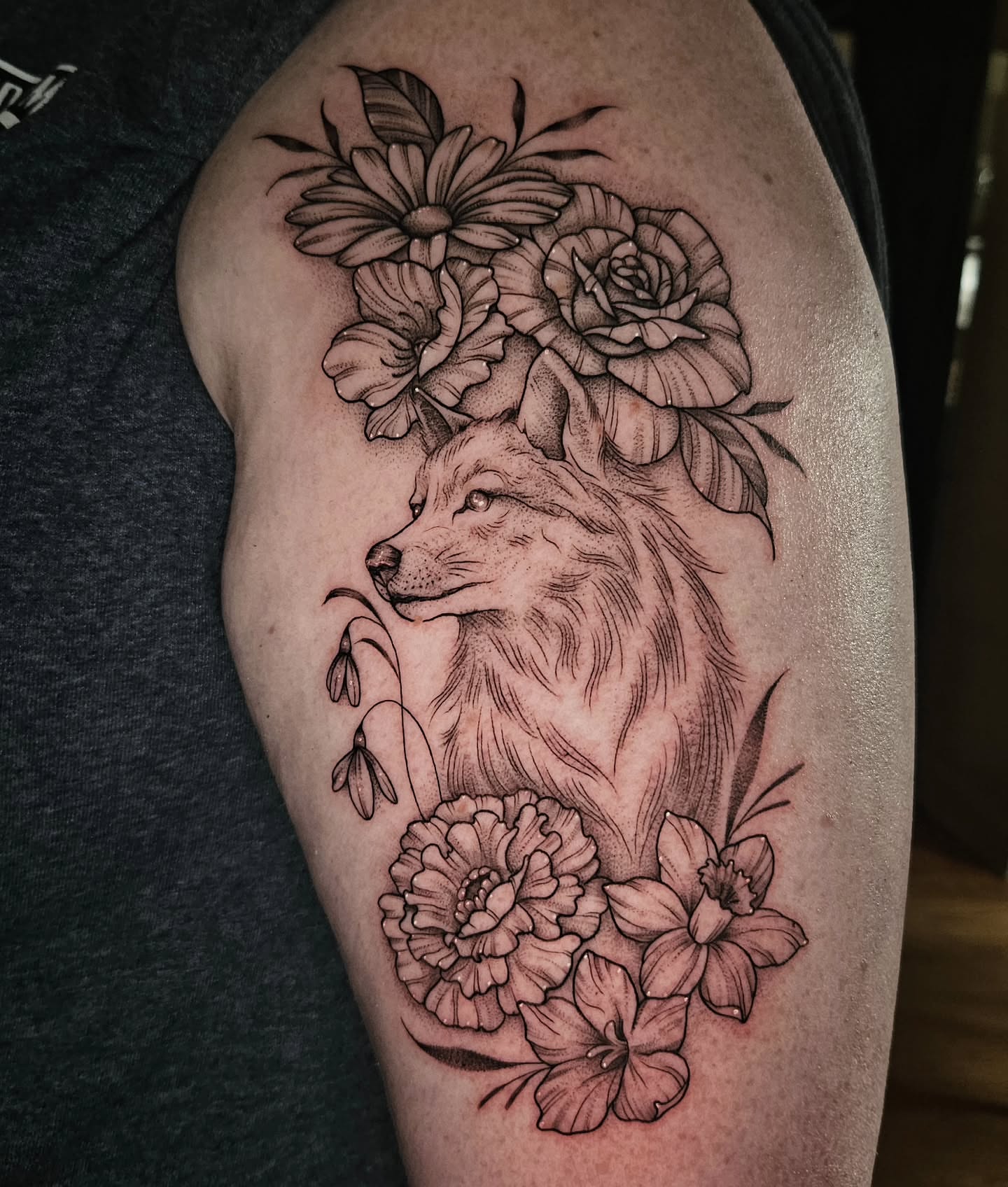 Wolf and flowers realism tattoo on the thigh by Courtlyn Bliss